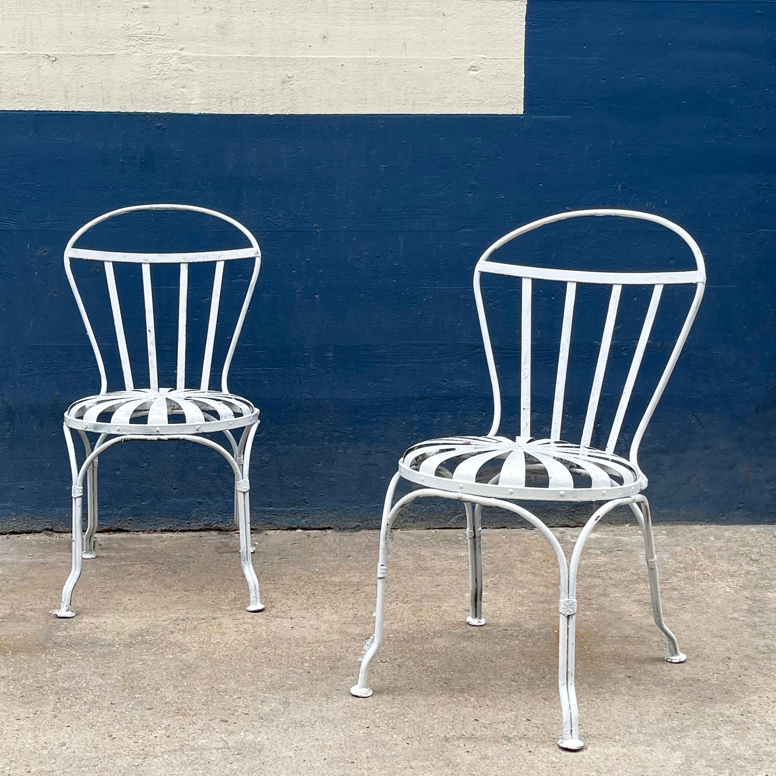 Pair of Art Deco, painted wrought iron, outdoor, garden side chairs by Francois Carré feature sunburst motif seats.