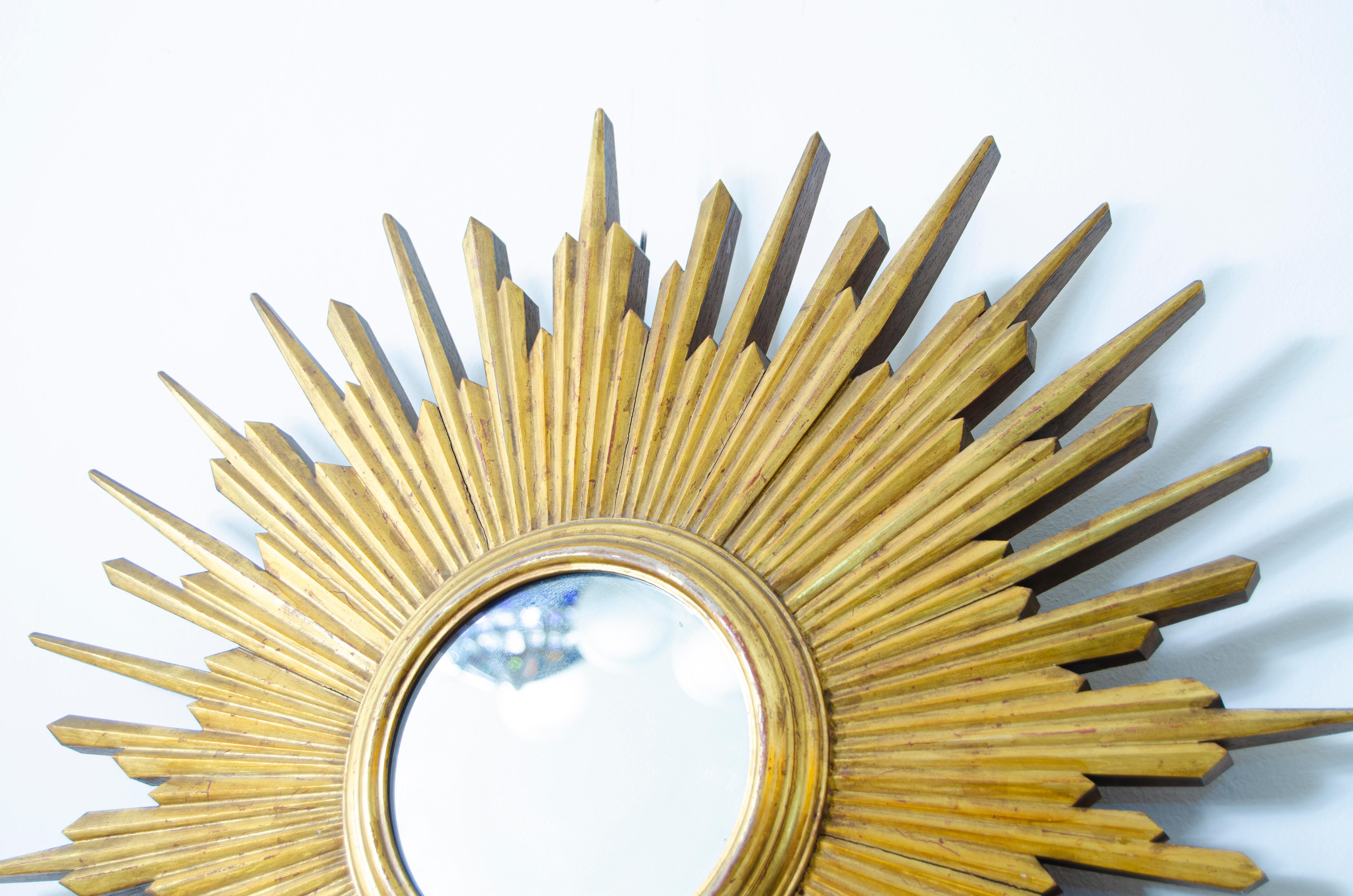 Mid century Sunburst Gilt-wood Mirror. Original gilt finish on the finely carved wooden trays, with original mirror. 

France, CIRCA 1950.