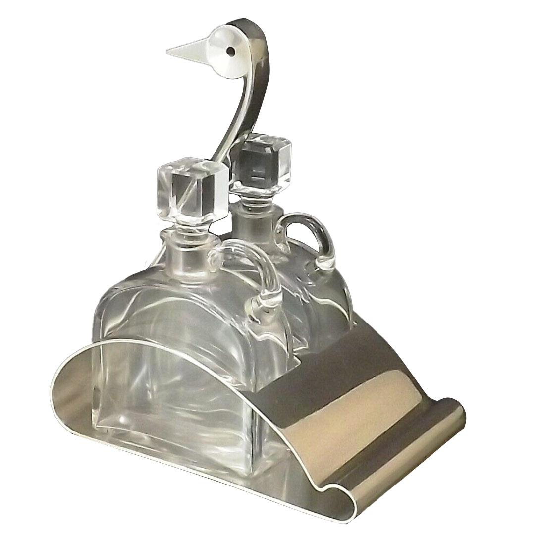 Swan-shaped silverplated oil and vinegar stand with two small Baccarat crystal bottles with canted corners and stoppers. Design by Christian Fjerdingstad (1891-1968) for Christofle, Gallia Collection circa 1925.
Stamped with Christofle and Gallia