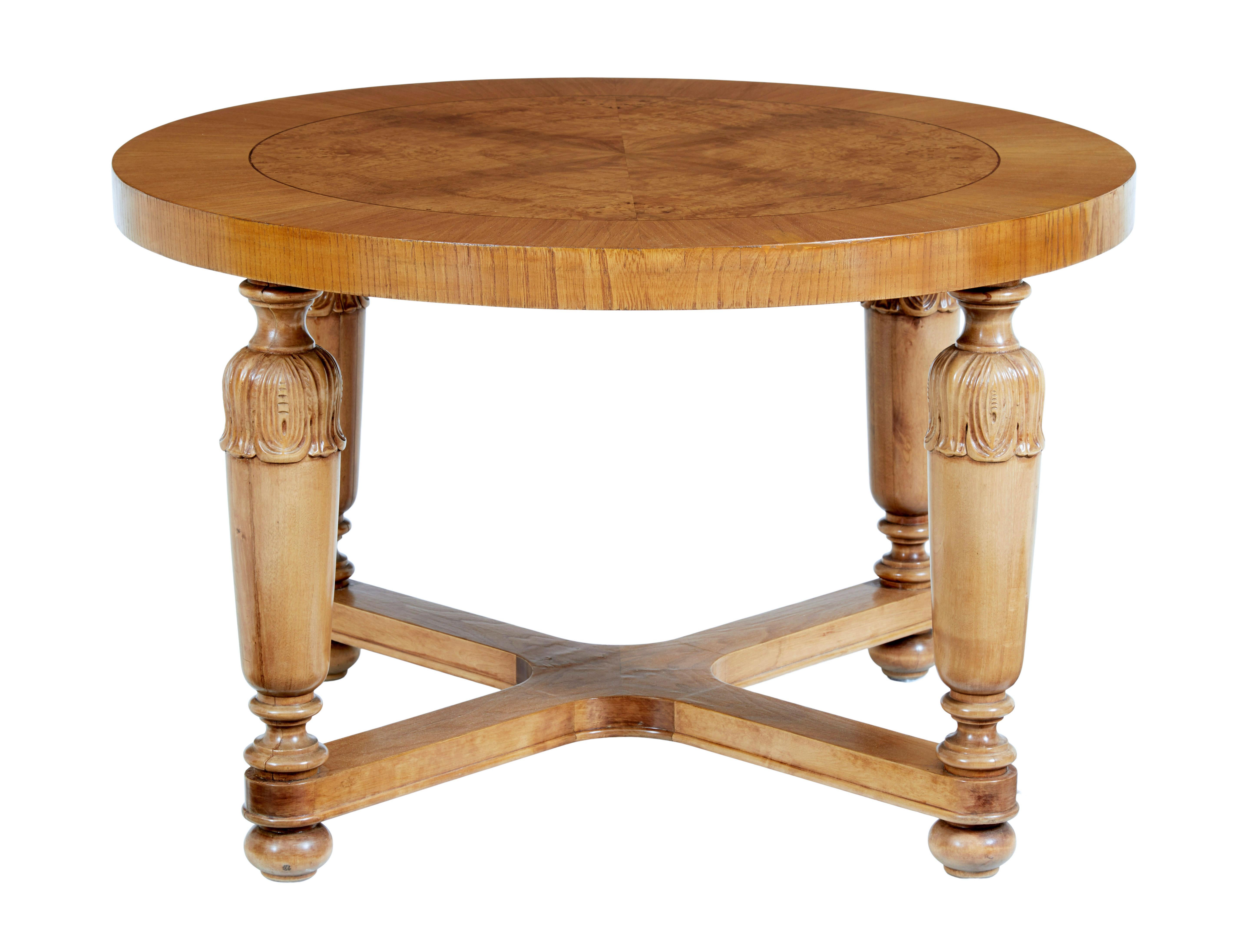 Art deco Swedish carved birch and elm coffee table, circa 1930.

Circular art deco period coffee, with quarter veneer burr birch center, strung edge and elm veneered outer edge. Standing on 4-carved legs which are slightly tapered, united by an