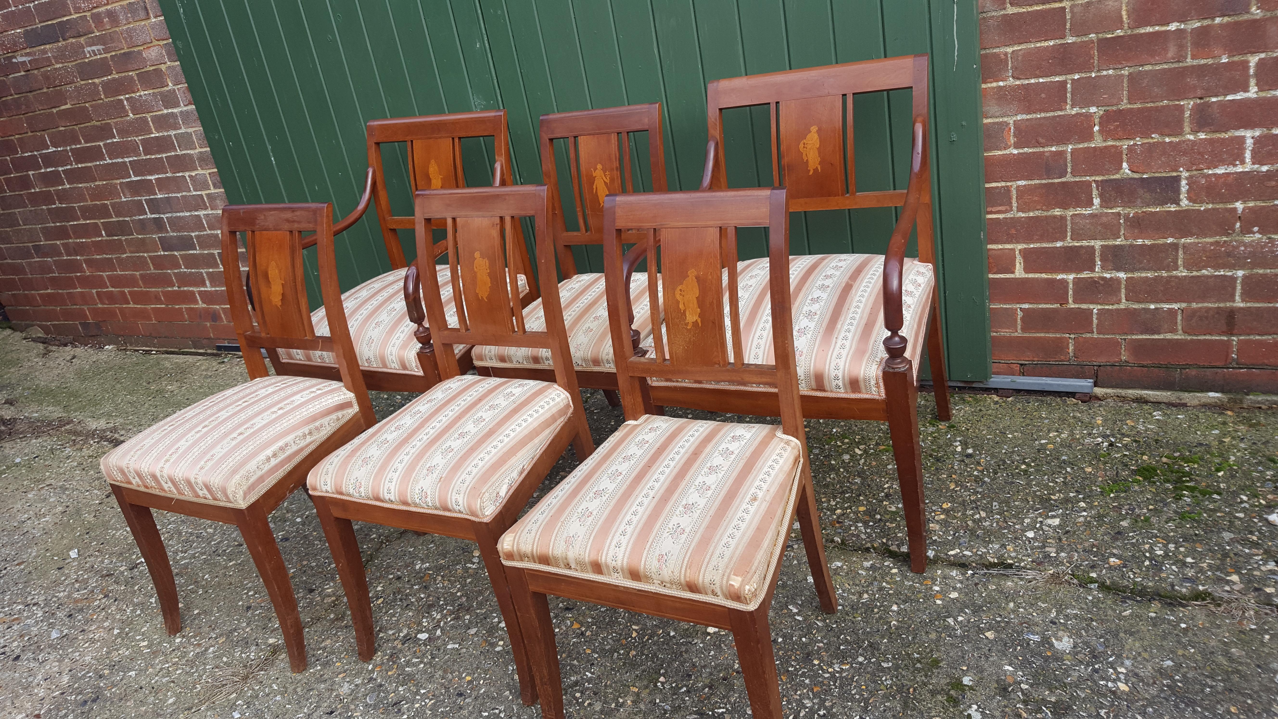 Set of 6 antique Swedish flame golden birch Art Deco dining chairs with the distinctive inlaid seat backs with beautiful detailed marquetry figures of woman.

The top grade flame veneers are brought to life by the sought after darker honey color