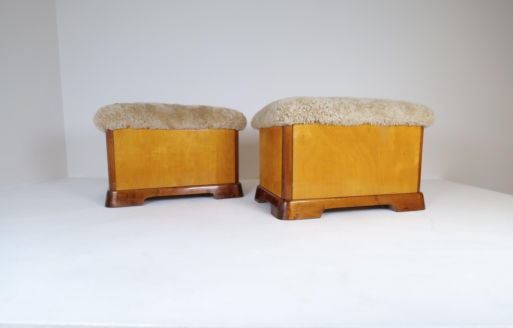 These rare Art Deco stools was made in Sweden during the 1930-40s. 
Wonderfully crafted legs with middle part being in brighter birch, the seat newly upholstered in sheepskin/shearling. 

Good vintage condition with a beautiful patina, all new