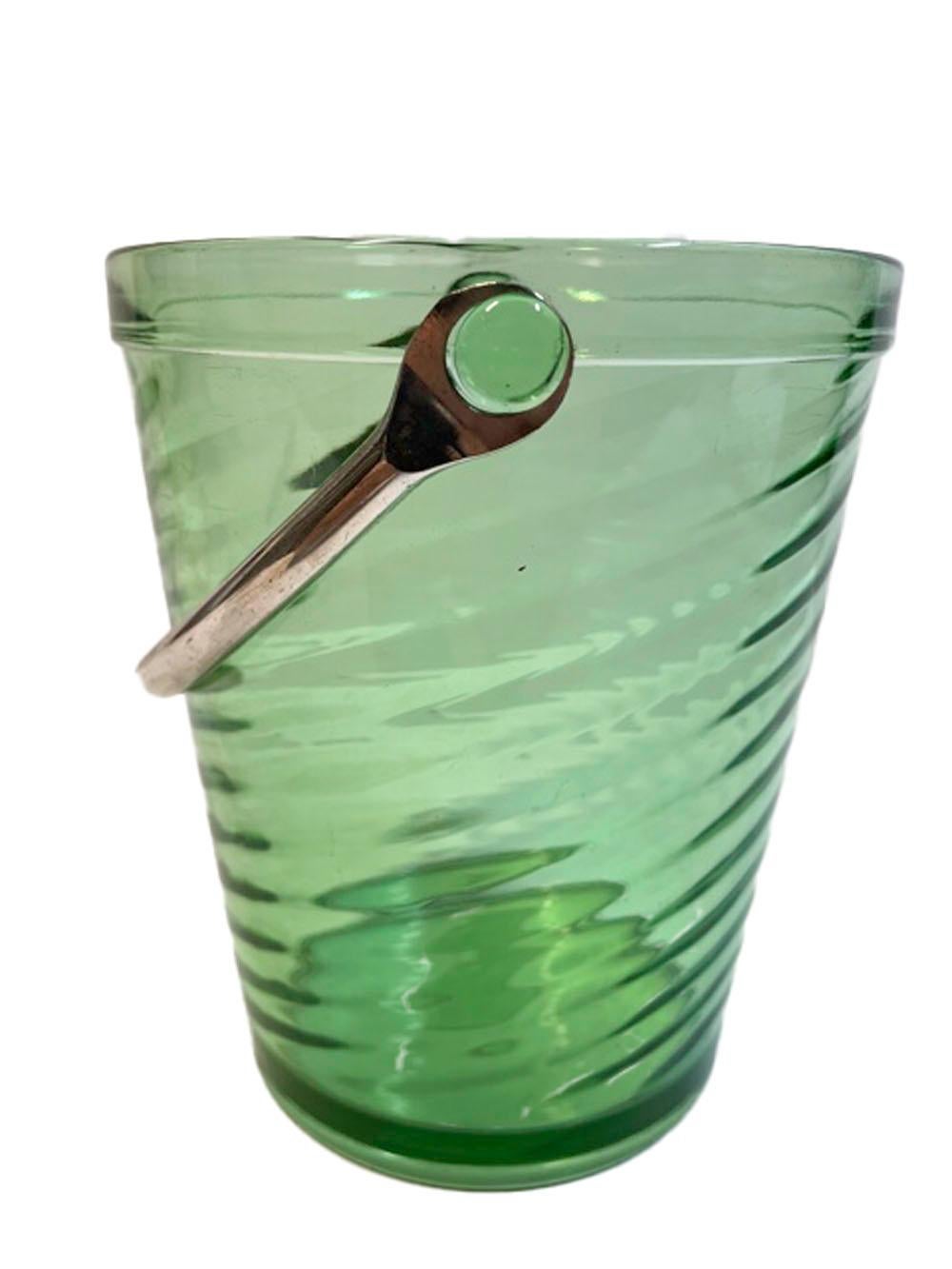 Vintage ice bucket of pail form with an optical swirled glass body and metal swing handle attached to lugs along the rim.