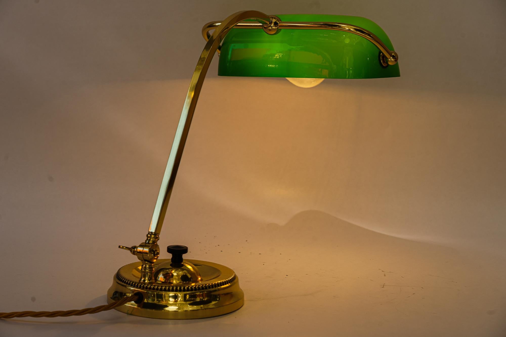 Brass Art Deco swiveling banker table lamp with green glass vienna around 1920s For Sale