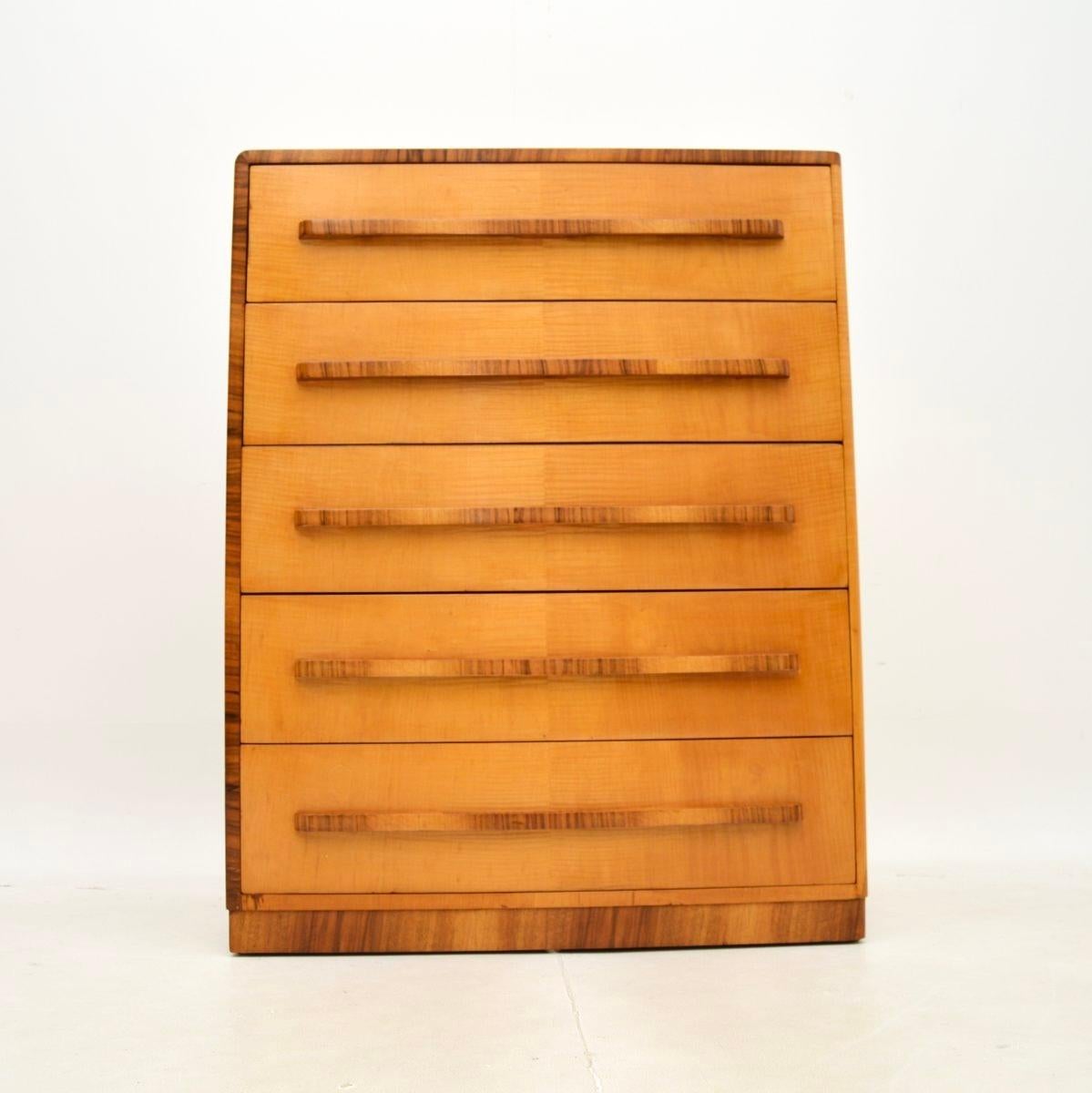 A magnificent art deco sycamore and walnut chest of drawers, this is of the absolute highest order. It was made in England, it dates from the 1930’s.

The quality is outstanding, this is beautifully made and has a unique design aspect. It is