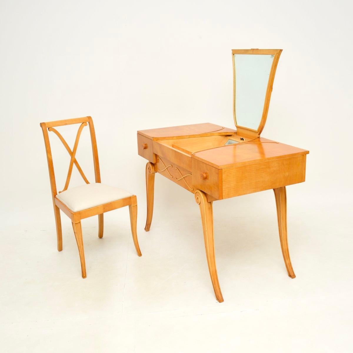 An absolutely stunning vintage Art Deco sycamore dressing table and chair by Hille. This was made in England, it dates from the 1920’s.

This is of superb quality and has an incredibly elegant design. The table stands on beautifully scrolled legs,