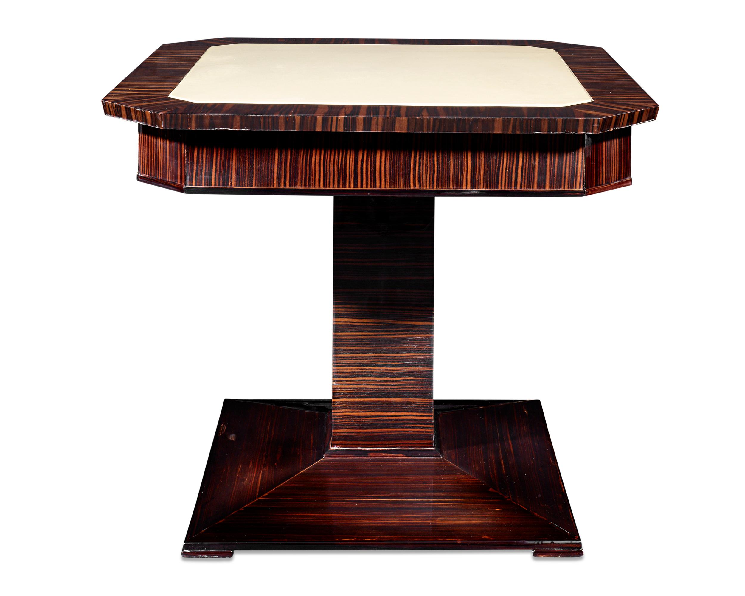 The splendor and elegance of Art Deco design are beautifully illustrated by this fine French card table and chairs set. Crafted of luxurious rosewood, the table features canted edges, an inlaid leather top and a banded apron atop a squared column