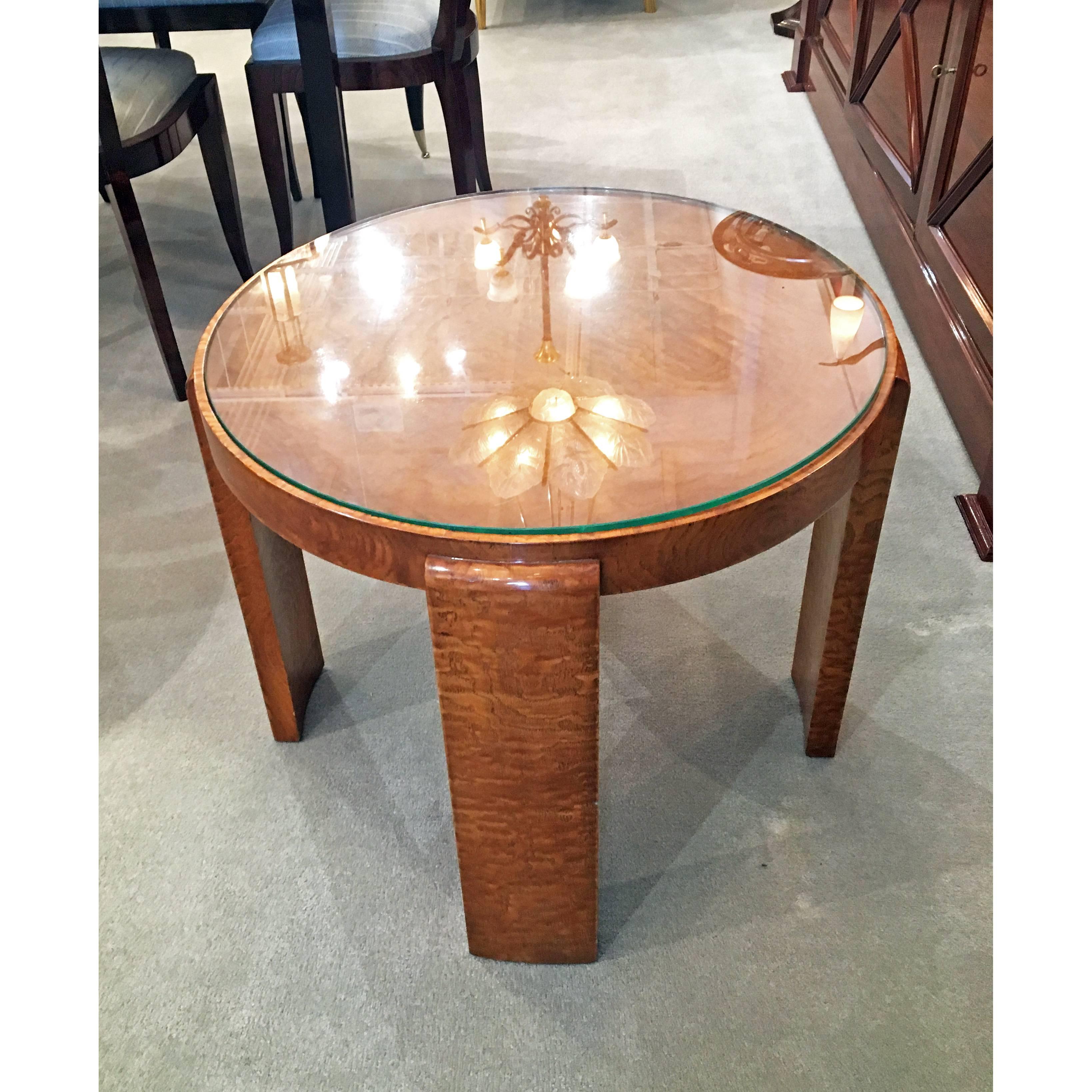 Art Deco round table made of Amboyna wood with a glass top by Jacques Adnet.
Made in France, 
circa 1940
Reference: same piece shown Jacques Adnet by Alain-Rene Hardy - Gaelle Millet, Page 41.