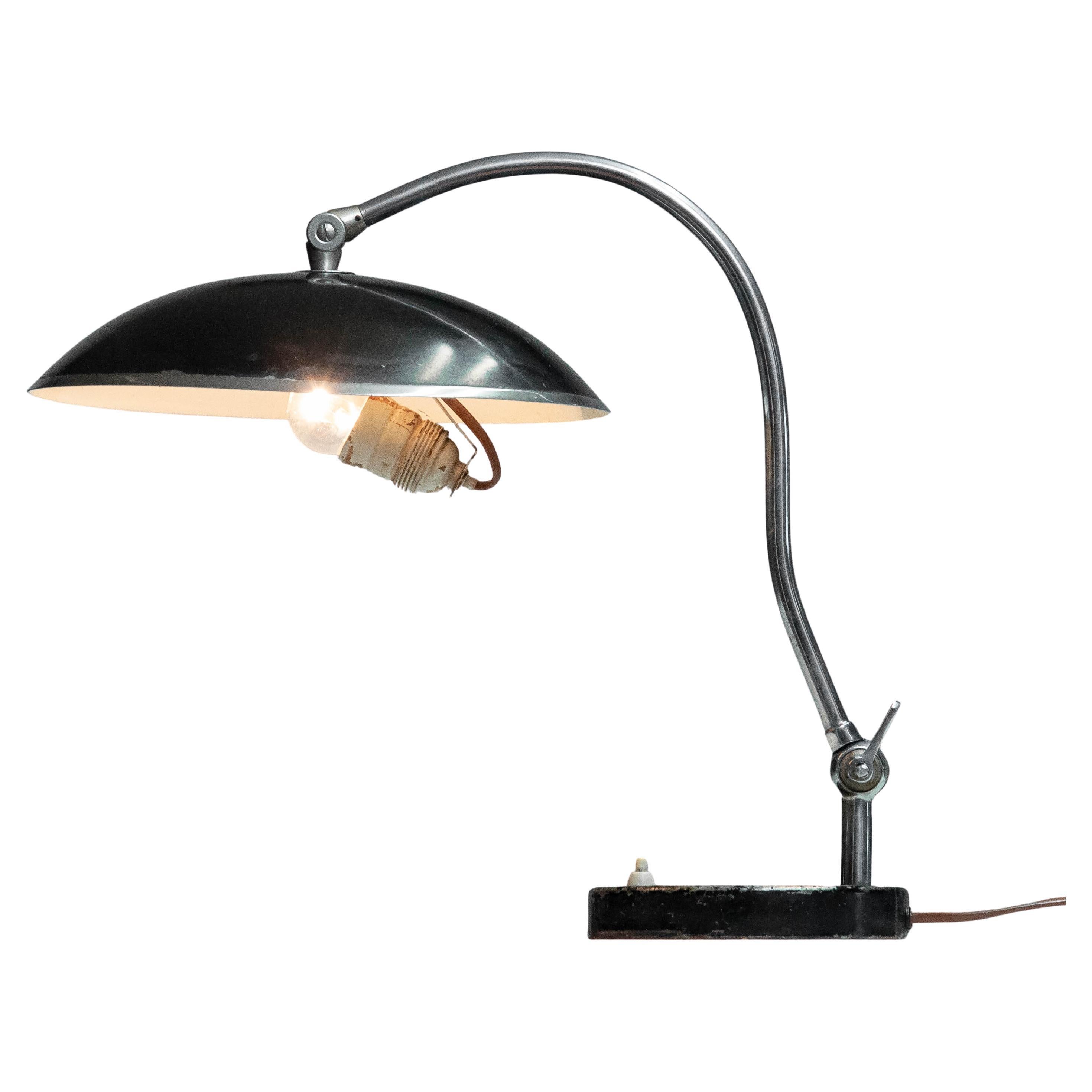 Beautiful chrome with black lacquered Art Deco Table Lamp from Sweden with fixed tilted disk model shade. 
This Table Lamp is a perfect statement piece for mid-century, Art Deco, or modern interiors.
All over in good condition and technically