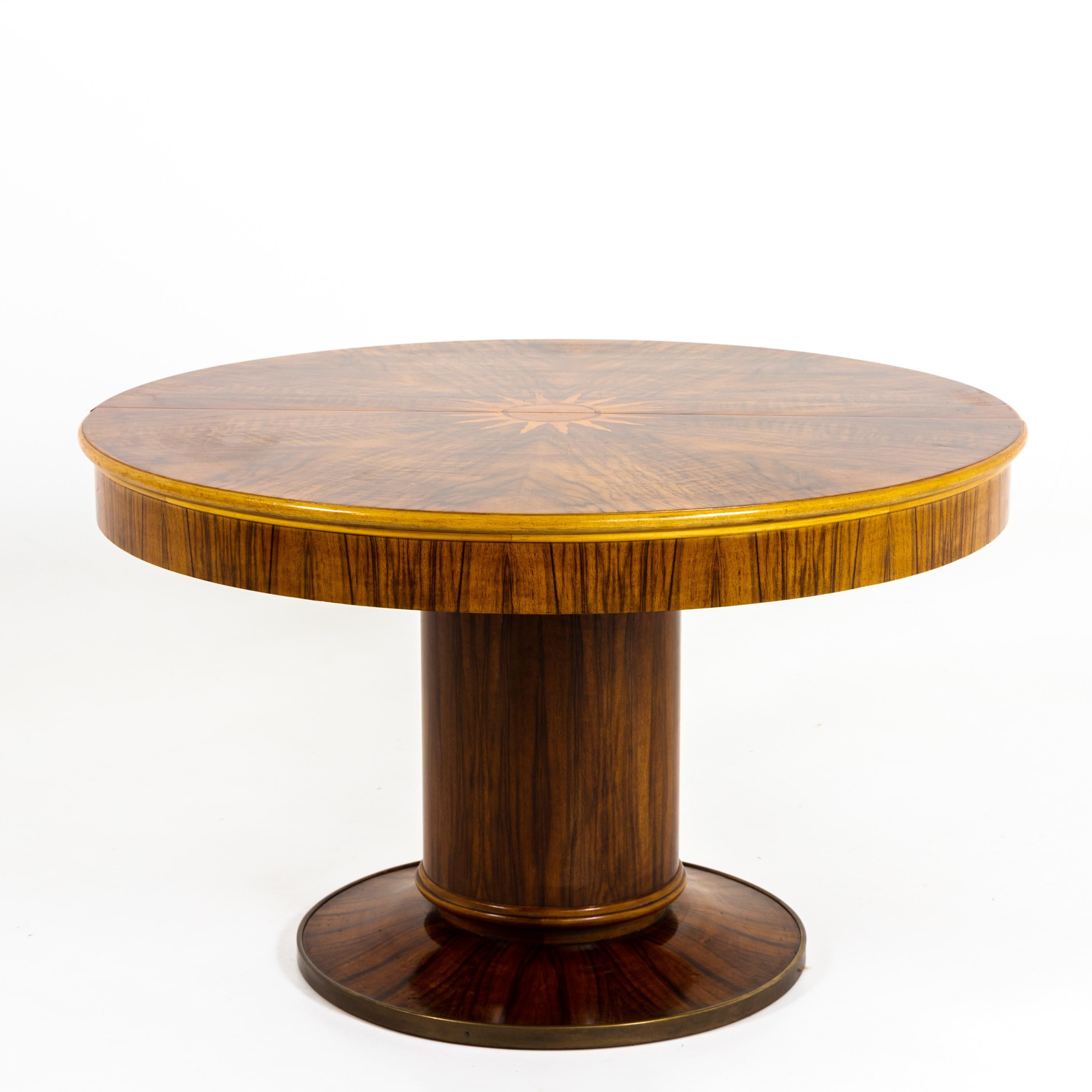Art Deco extension table with round column base and table top, in walnut veneer with central inlay in the shape of a sun. The table was professionally refurbished and hand polished.