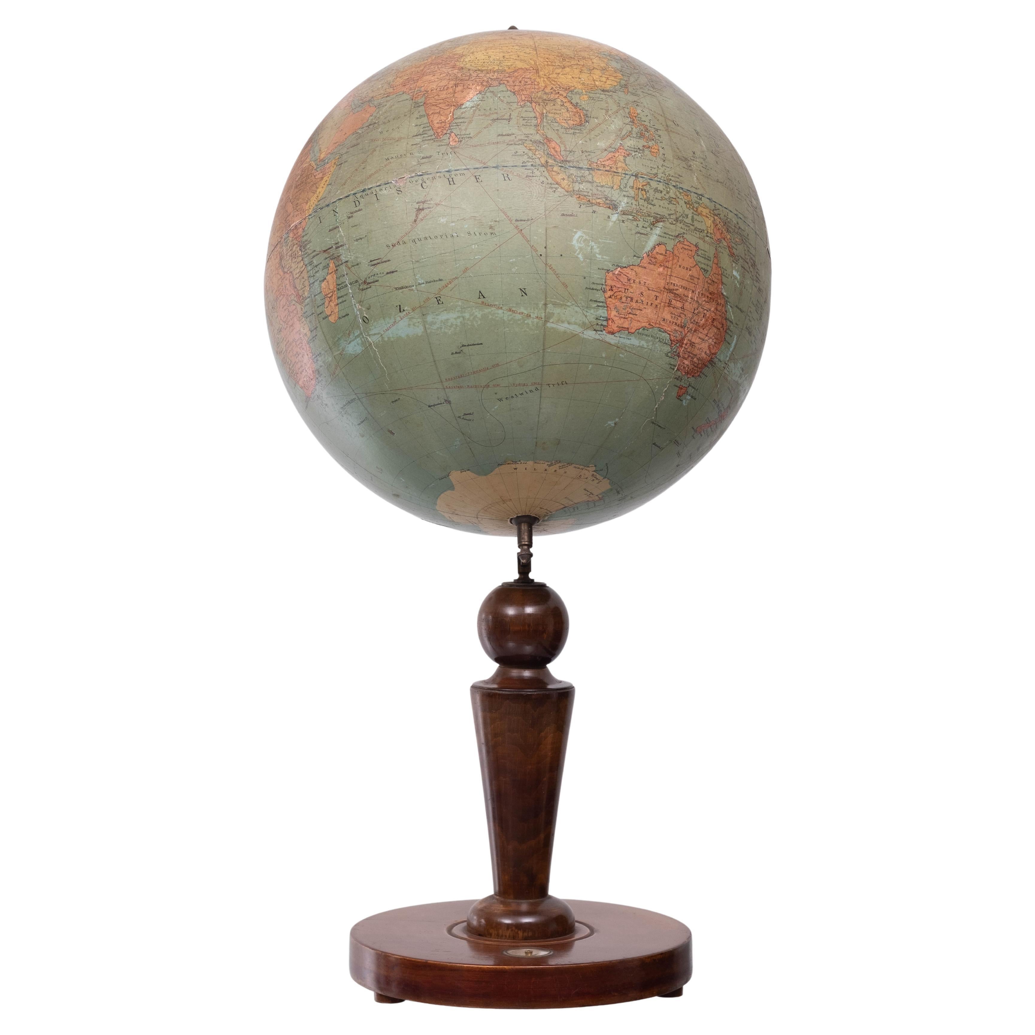 German table Erdglobus der Deutschen Buch-Gemeinschaft by Dietrich Reimer Ernst Vohsen Berlin 
1920/30 Wooden globe with a lithograph on paper. On a walnut stand comes with a little compass in the base.
Original piece. This globe is in a used