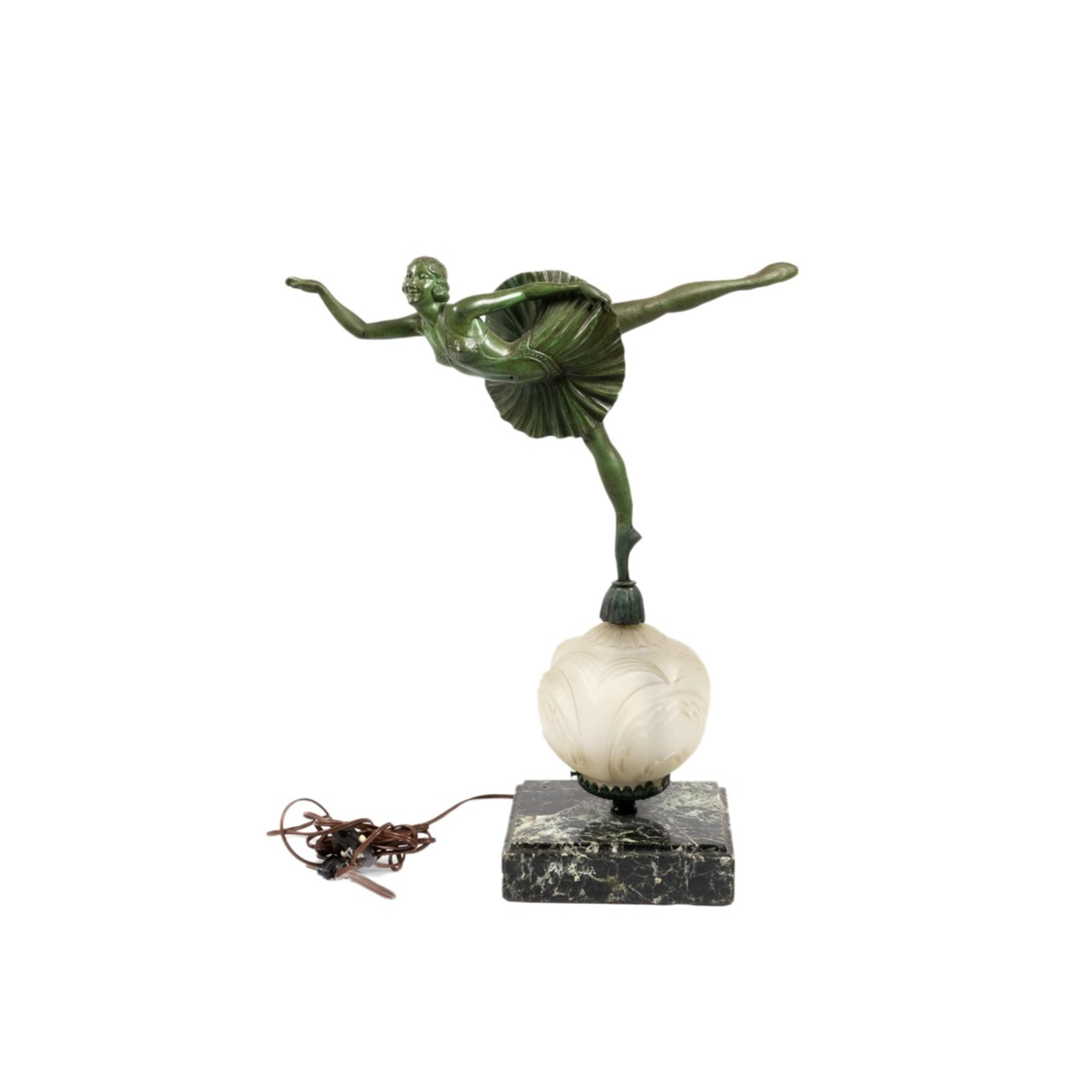 A patinated metal Art Deco figurine of a ballerina standing on one foot, a Dominique Alonzo model, in green patine with frosted glass and a green marble base.
