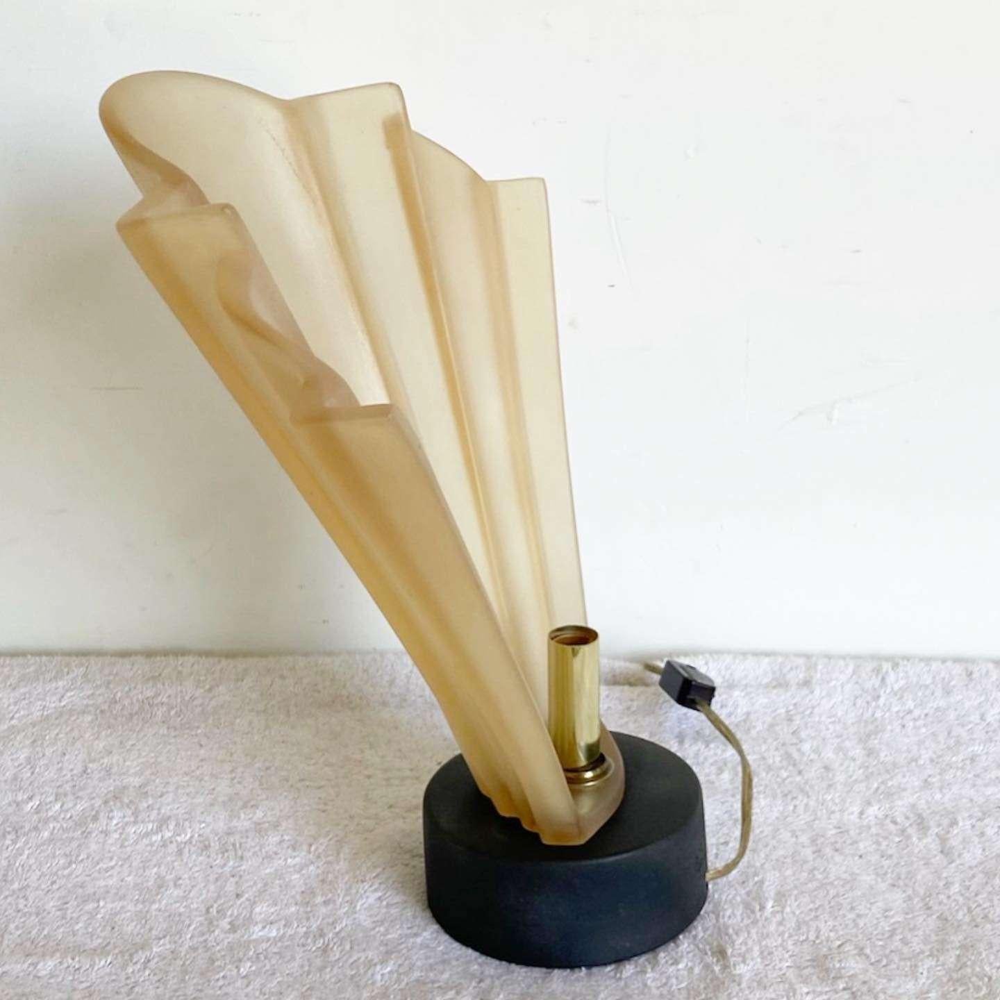 Wonderful vintage art deco style table lamp by Paolo Gucci. Features a tan resin lamp shade scalloping in front of the light.