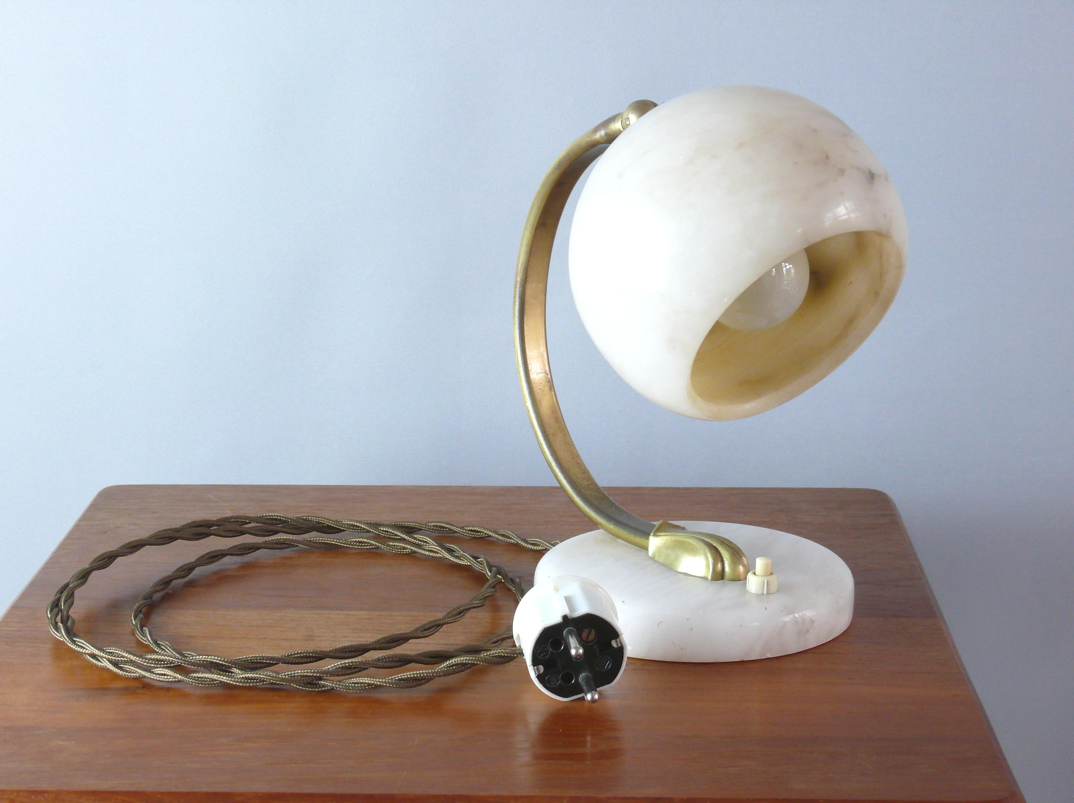 Lampe de table Art déco en marbre et laiton des années 1930 en bon état, un beau témoignage de l'époque Art déco. La lampe est équipée d'une douille en plastique E 27 et la hauteur de l'abat-jour peut être réglée à l'aide d'une vis à oreilles. Le