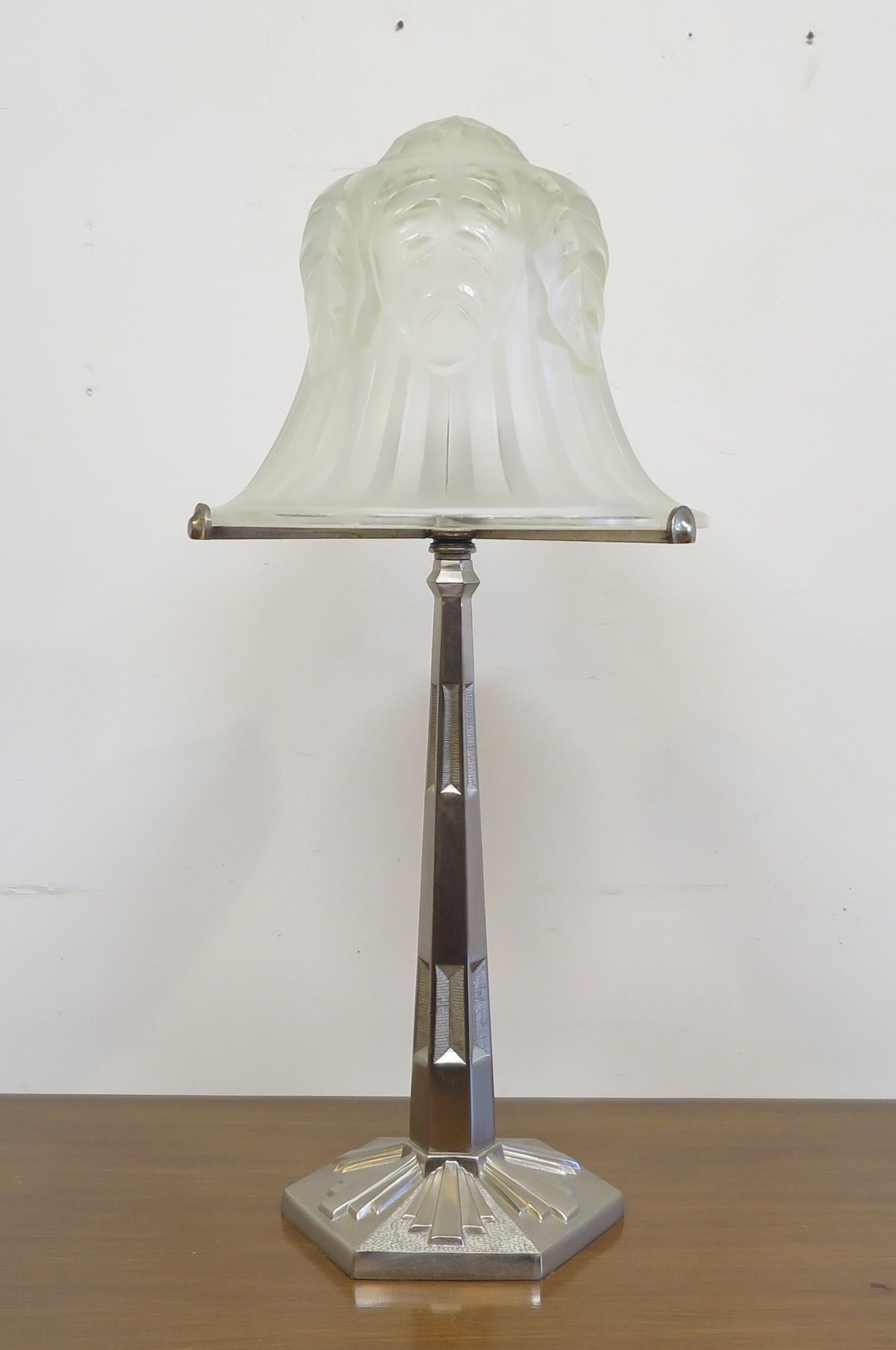 Art Deco table lamp.. Art Deco motif incised hexagonal nickel-plated stem and base with burst pattern. Beautiful original thick molded glass shade diffuser with hand cut details to the top. . In good condition.  A wonderful Art Deco Table Lamp in