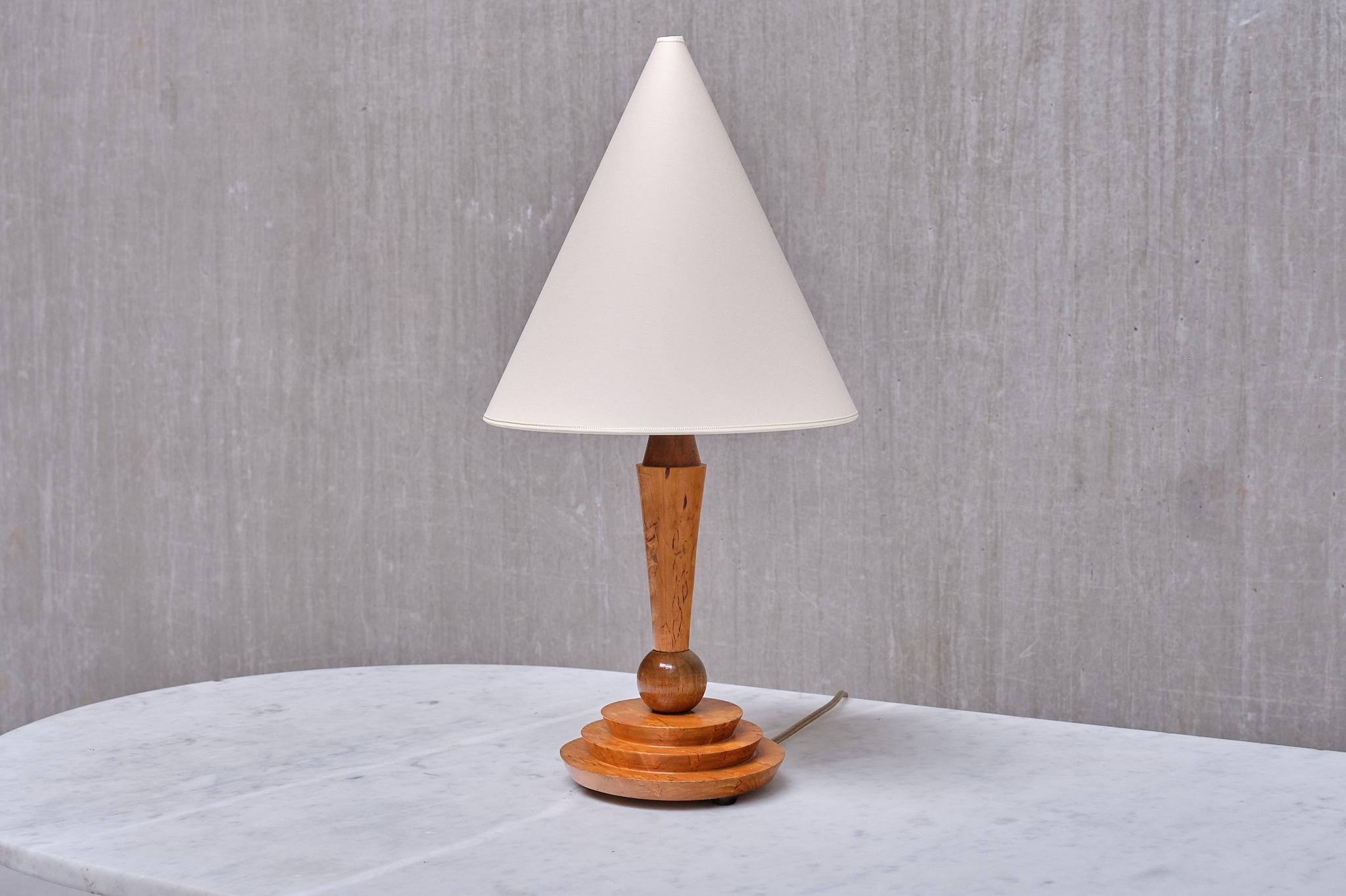 This striking Art Deco table lamp was produced in Austria in the late 1930s. 

The design is marked by the elegant shape of the base which has executed in lacquered maple and Birdseye maple wood. The lamp consists of a three tiered circular base,