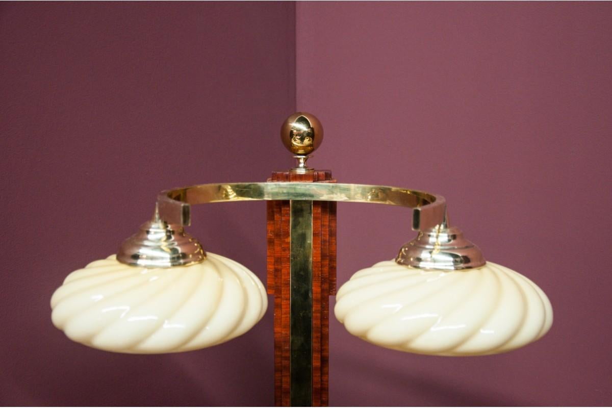 Art Deco table lamp.
Made of walnut wood and metal parts. 
Beige glass lampshades. 
New efficient wires with european plug. 
Very good condition.

Dimensions: height 61 cm / diameter 40 cm.
 