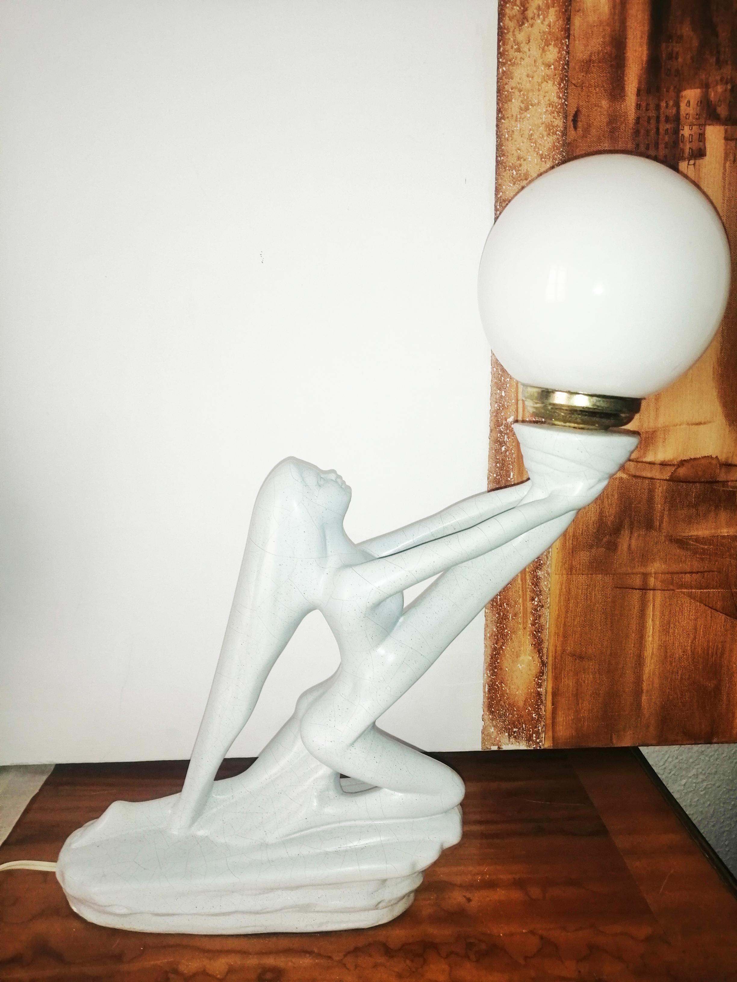 Art Deco table lamp shaped sculpture of a young lady in porcelain and opaline glass balloon.
 