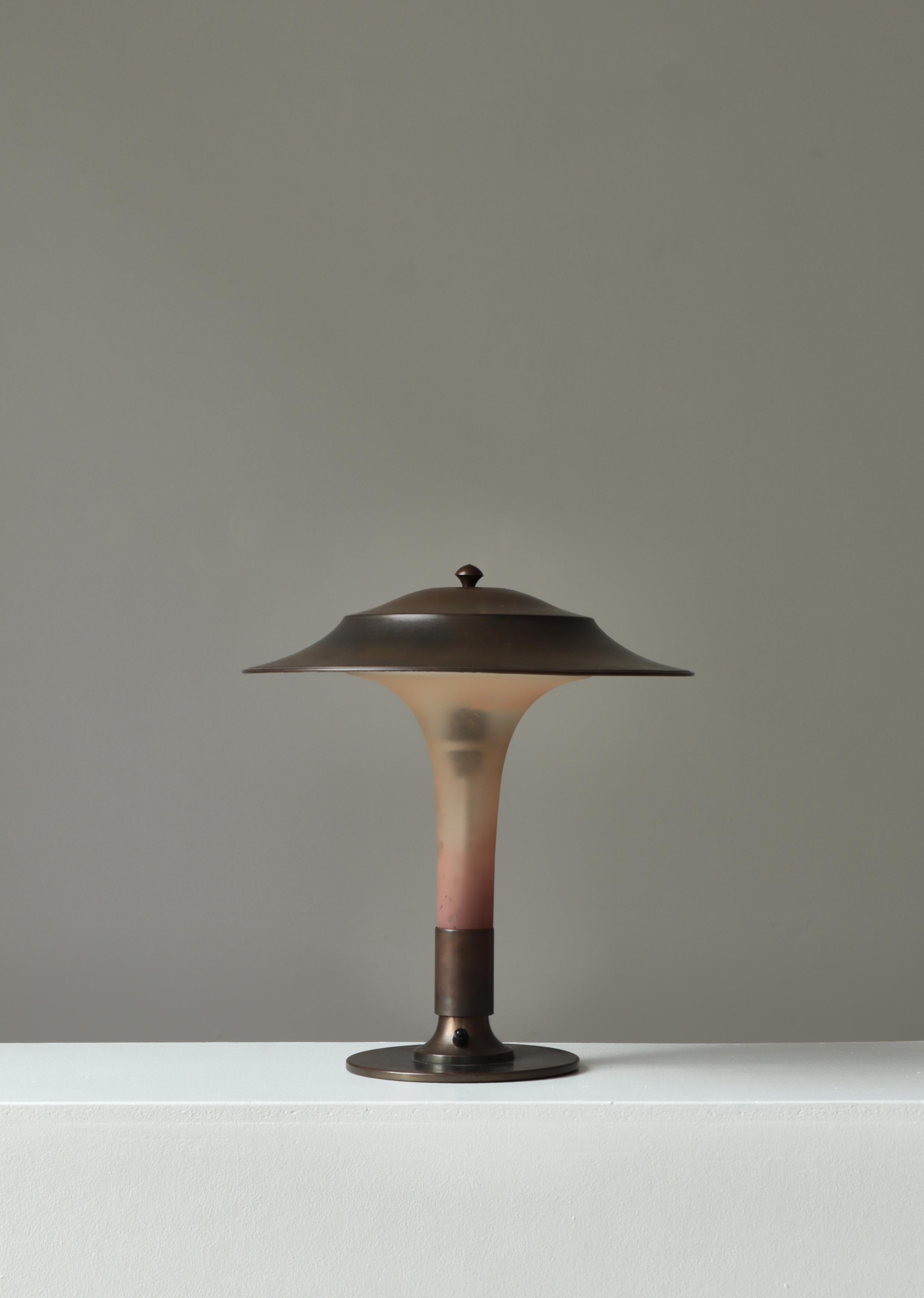 Etonnante lampe de table danoise Art Déco avec tige en verre ambré, abat-jour et base en laiton patiné foncé. La lampe a été fabriquée par Fog & Morup, à Copenhague, dans les années 1930 et est en bon état d'origine. Ce modèle est surnommé 