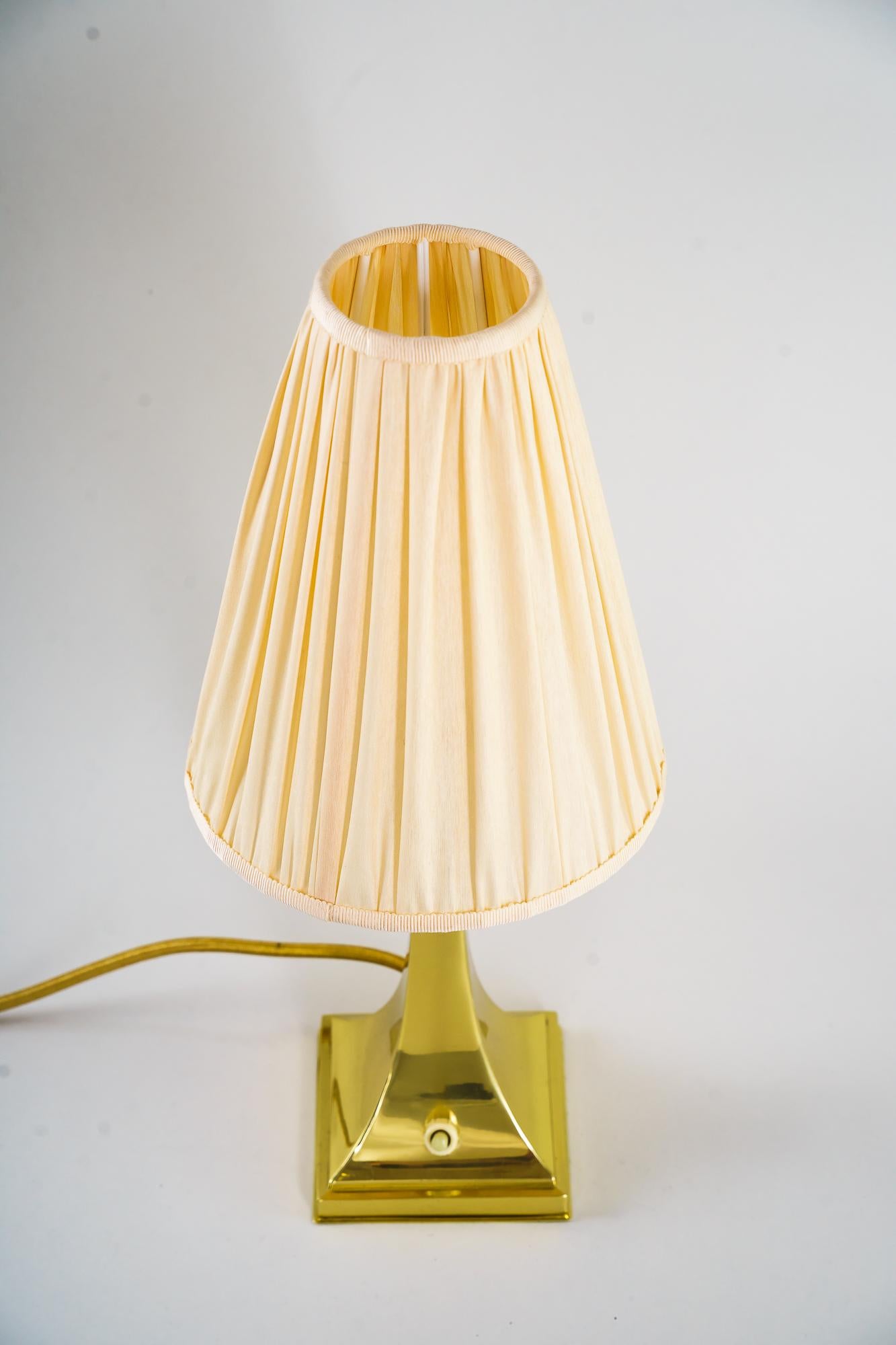 Lampe de table Art Déco avec abat-jour en tissu vers 1920
Laiton poli et poêle émaillé
L'abat-jour est neuf (remplacé).