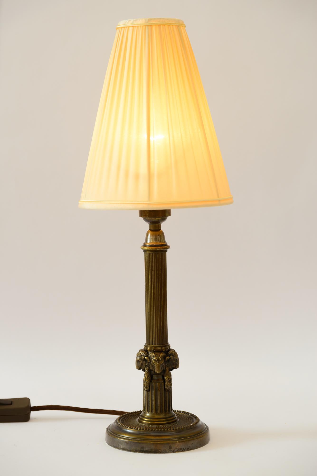 Laiton Lampe de table Art déco avec tête de capricorn et abat-jour en tissu vienna vers les années 1920 en vente
