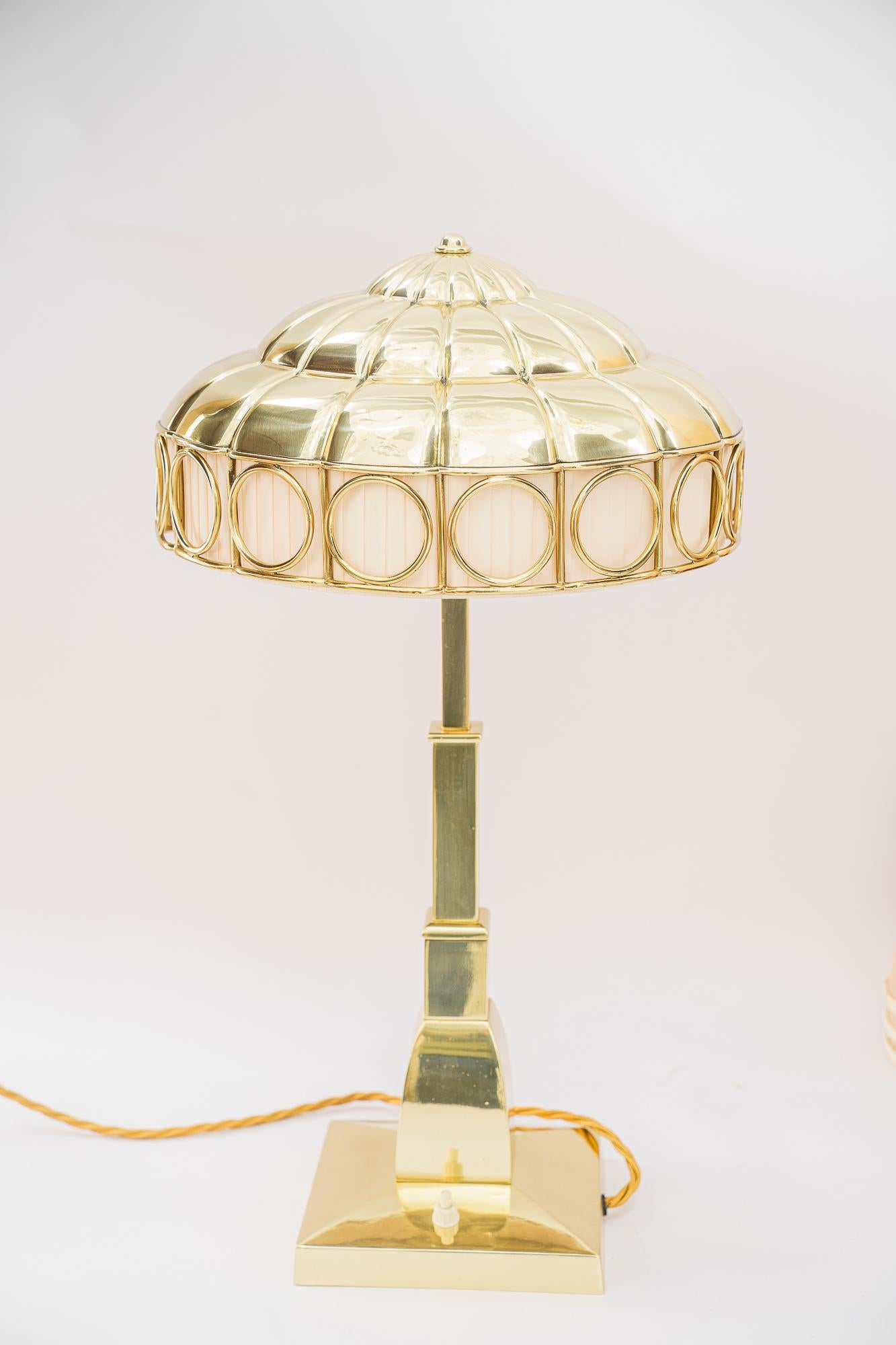 Art Deco table lamp with fabric inside the shade vienna around 1920s
The fabric inside the shade is replaced ( new )
Brass polished and stove enameled
