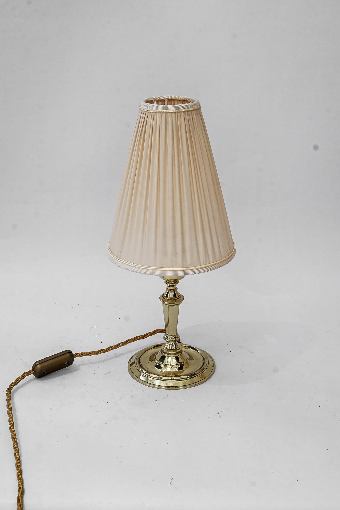 Art Deco  table lamp with fabric shade vienna around 1920s
Brass polished and stove enameled
The Fabric shade is replaced ( new )
