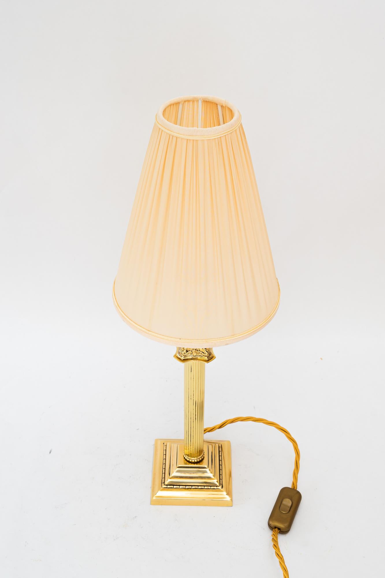 Art Deco table lamp with fabric shade vienna around 1920s
Brass polished and stove enameled
The fabric shade is replaced ( new )