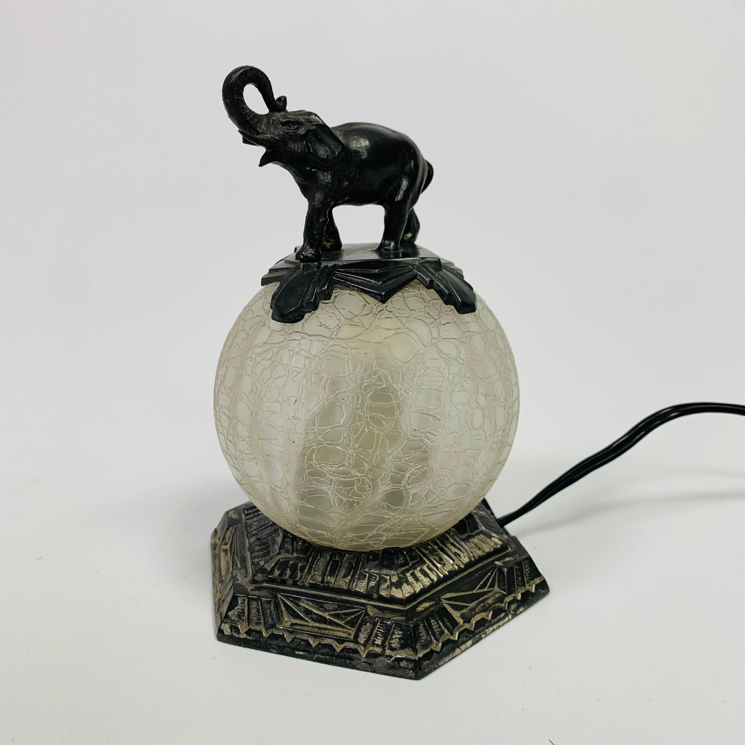 This lamp is made of a hexagonal metal
base, on which there is a glass crackled ball
(Ø: 10 cm) and at the very top is an elephant.
A light can be replaced with the 2 nuts under the
the base.

Height: 16.5 cm.
Width: 11 cm.
Depth: 12 cm.
The lamp is