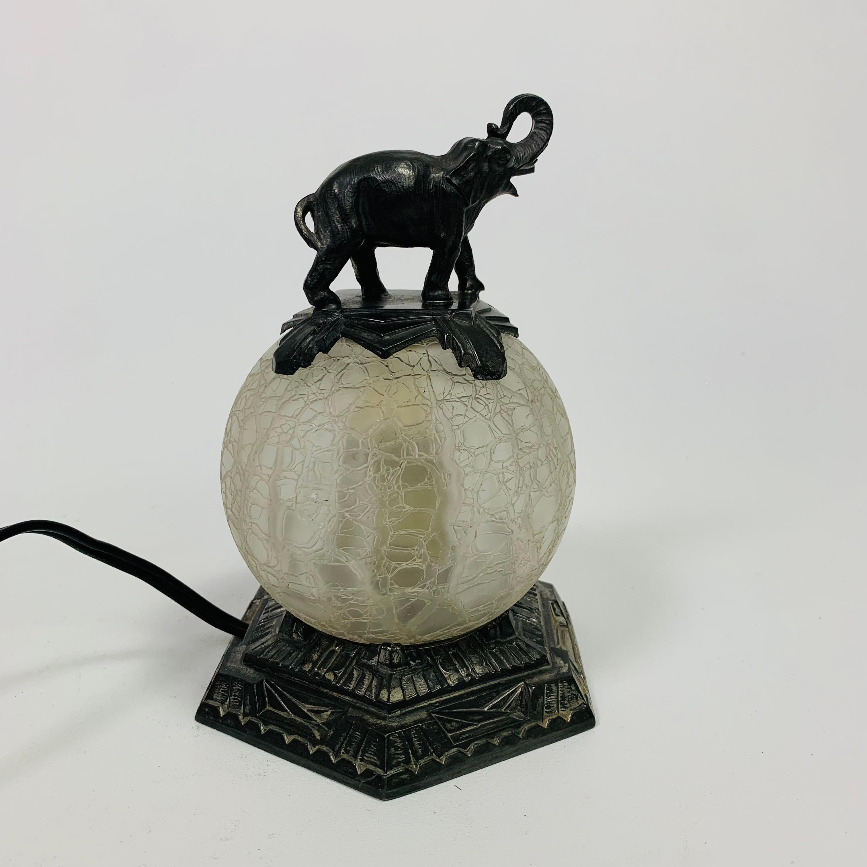 Metal Art Deco table lamp with glass ball and elephant on top, 1930s