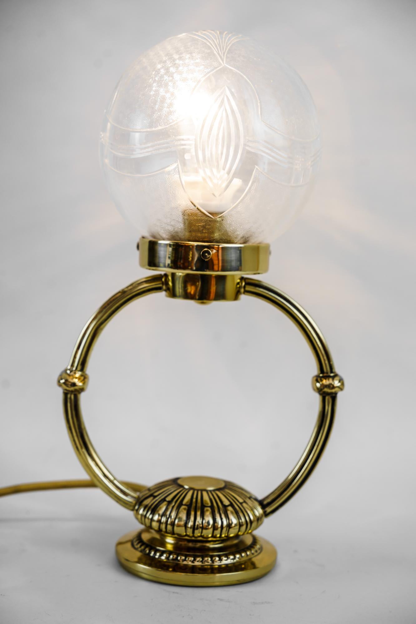 Art deco table lamp with original cut glass shade vienna around 1920s
Brass polished and stove enamelled.