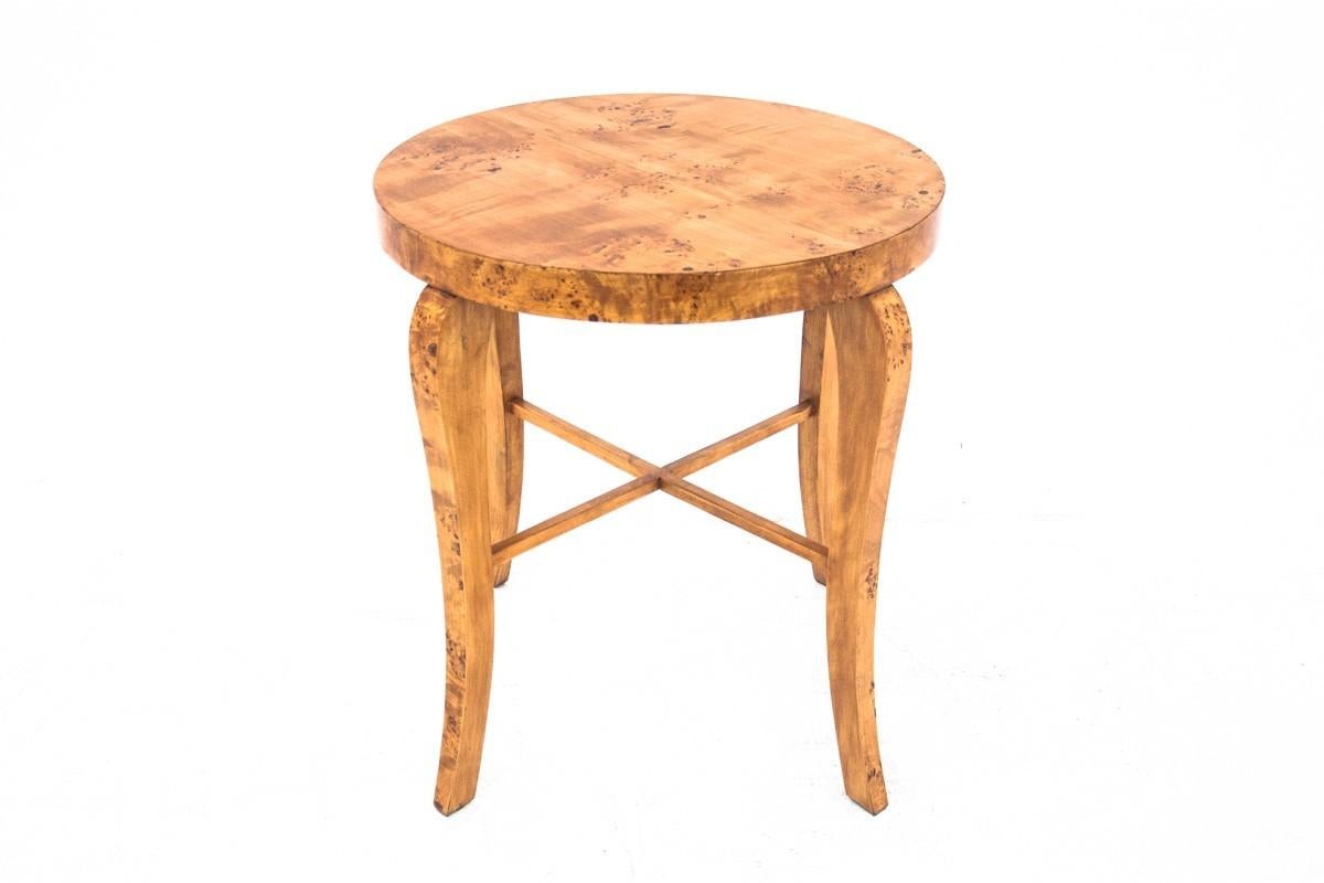 Original table from the first half of the 20th century in the Art Deco style. 

Stylish furniture with a beautiful form will add elegance to any interior. 

The furniture with a round top rests on gently curved legs fastened with a simple joint. The