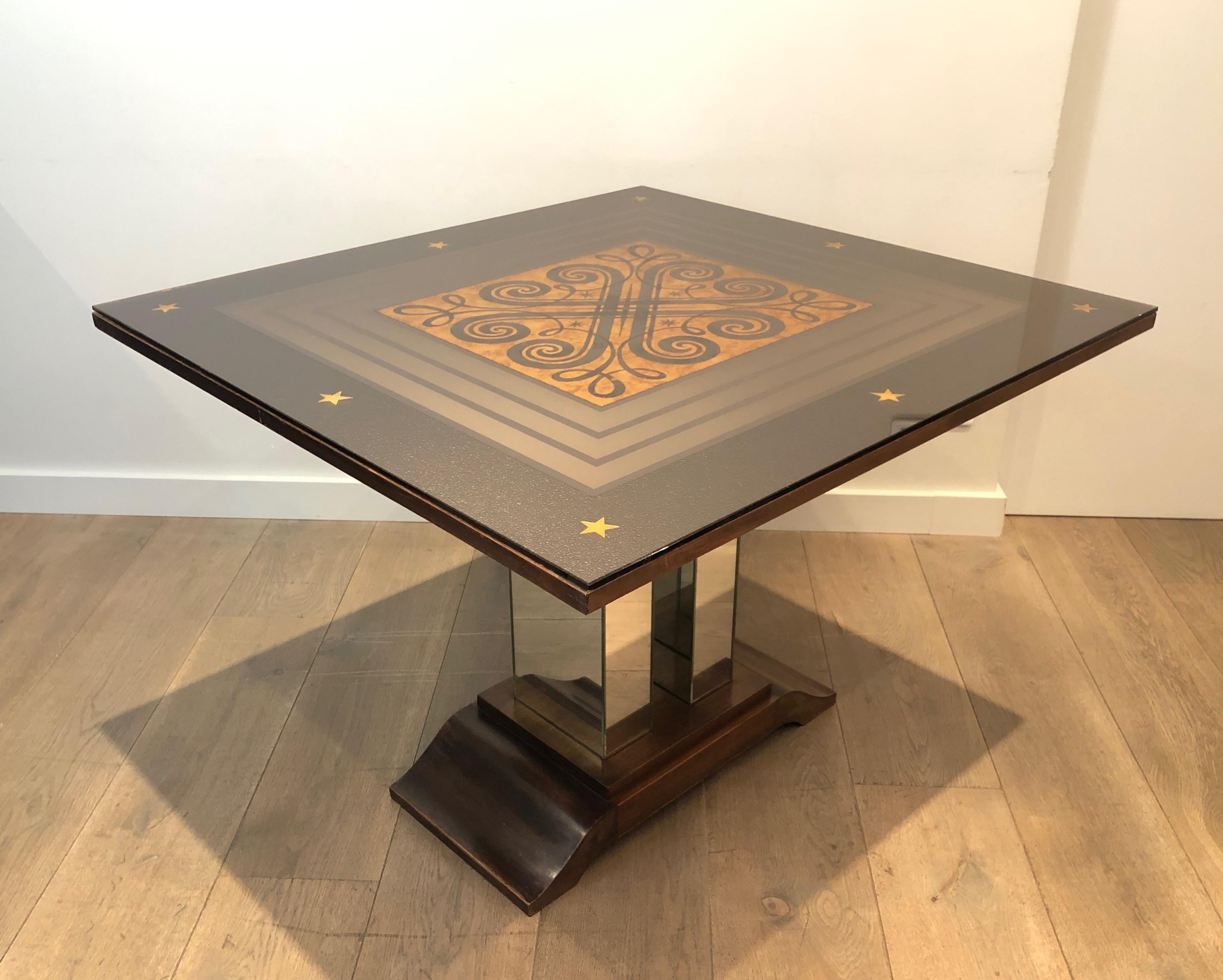 This Art Deco table is made of eglomised mirror top decorated with intertwined patterns on a base made of wood and mirrors. This is a French work in the Style of Jules Leleu and Max Ingrand. Circa 1930.