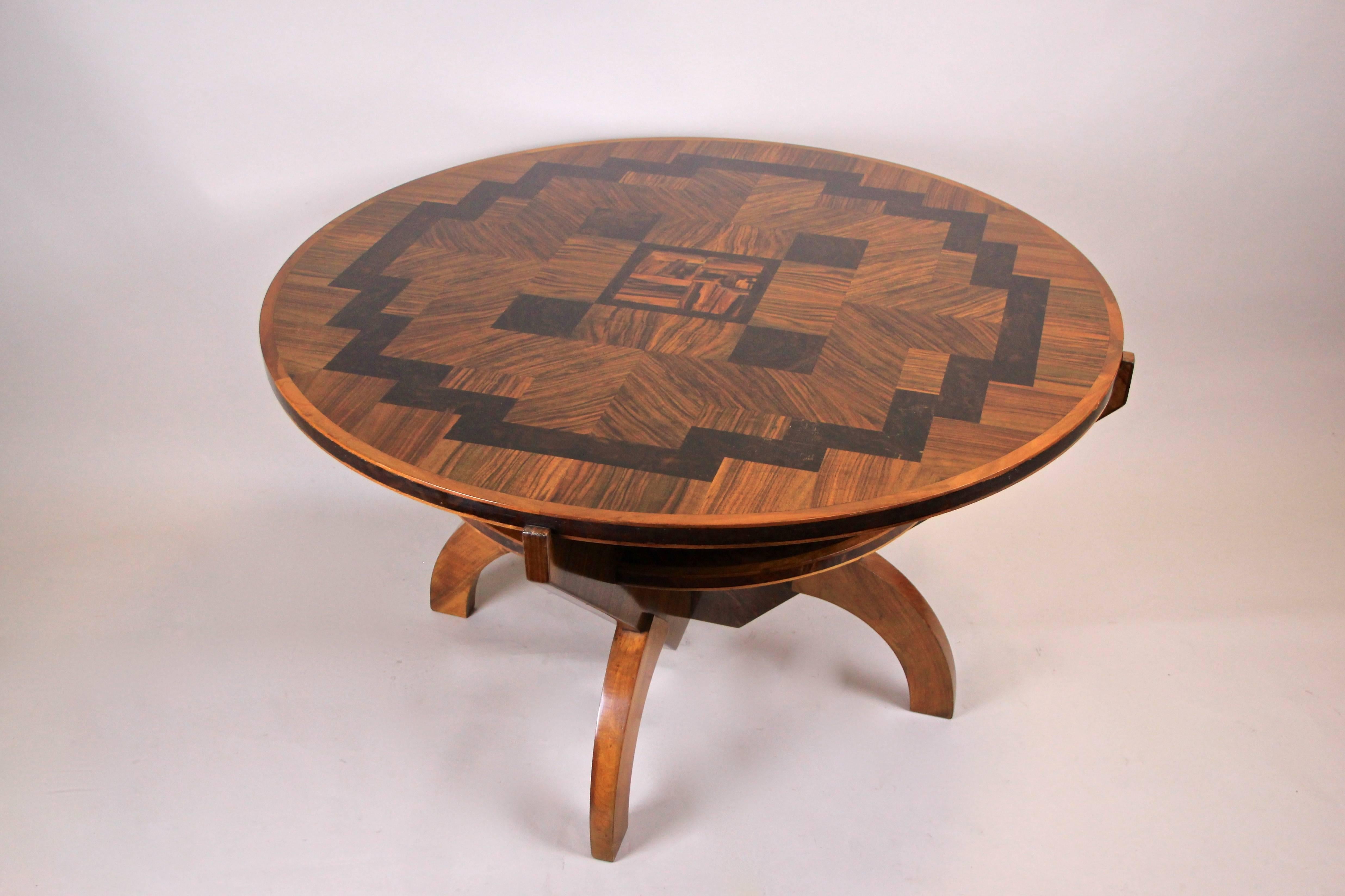 Exceptional round Art Deco table with marquetry work by Anton Herrgesell out of Vienna/ Austria from the era circa 1925. The unique designed table shows a great combination of different noble wood veneers. The round tabletop impresses with a