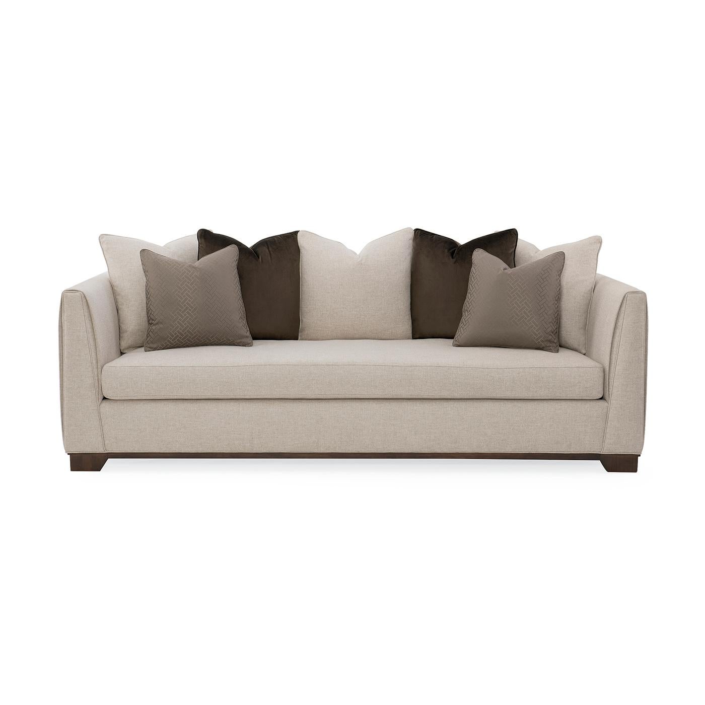 This sofa with squared corners is impeccably tailored. Fully encased in soft brushed neutral linen-look fabric, the back and arms have a vertical stitch detail and a slender blanket wrap feature that envelopes the tapered track arm design. The bench