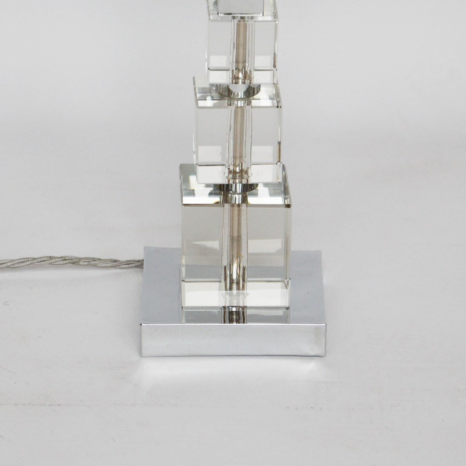 Art Deco table lamp with iceberg white glass shade and glass cubed stem set over a chromed metal base. 

Dimensions: H 44cm diameter of base, 10cm of shade, 11cm 

Origin: English

Date: circa 1930

Item Number: 1106203

All of our