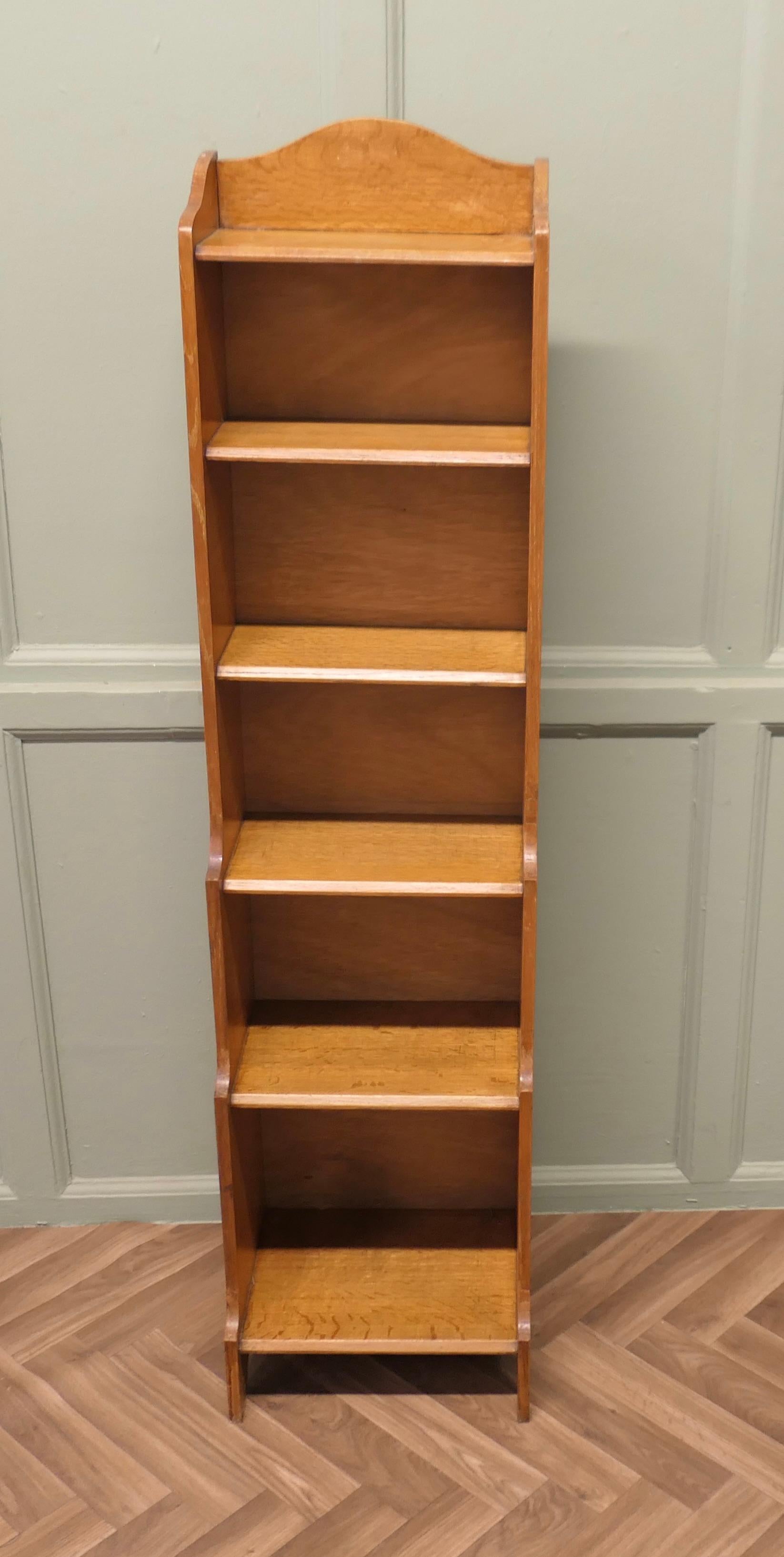 Art Deco Tall Slim Golden Oak Bookcase.

This Oak bookcase has a slight waterfall shape and 6 open shelves ranging from 11” to 7” in height with a gallery around the top, tall and sturdy a lot of storage in a small space

The bookcase is in good