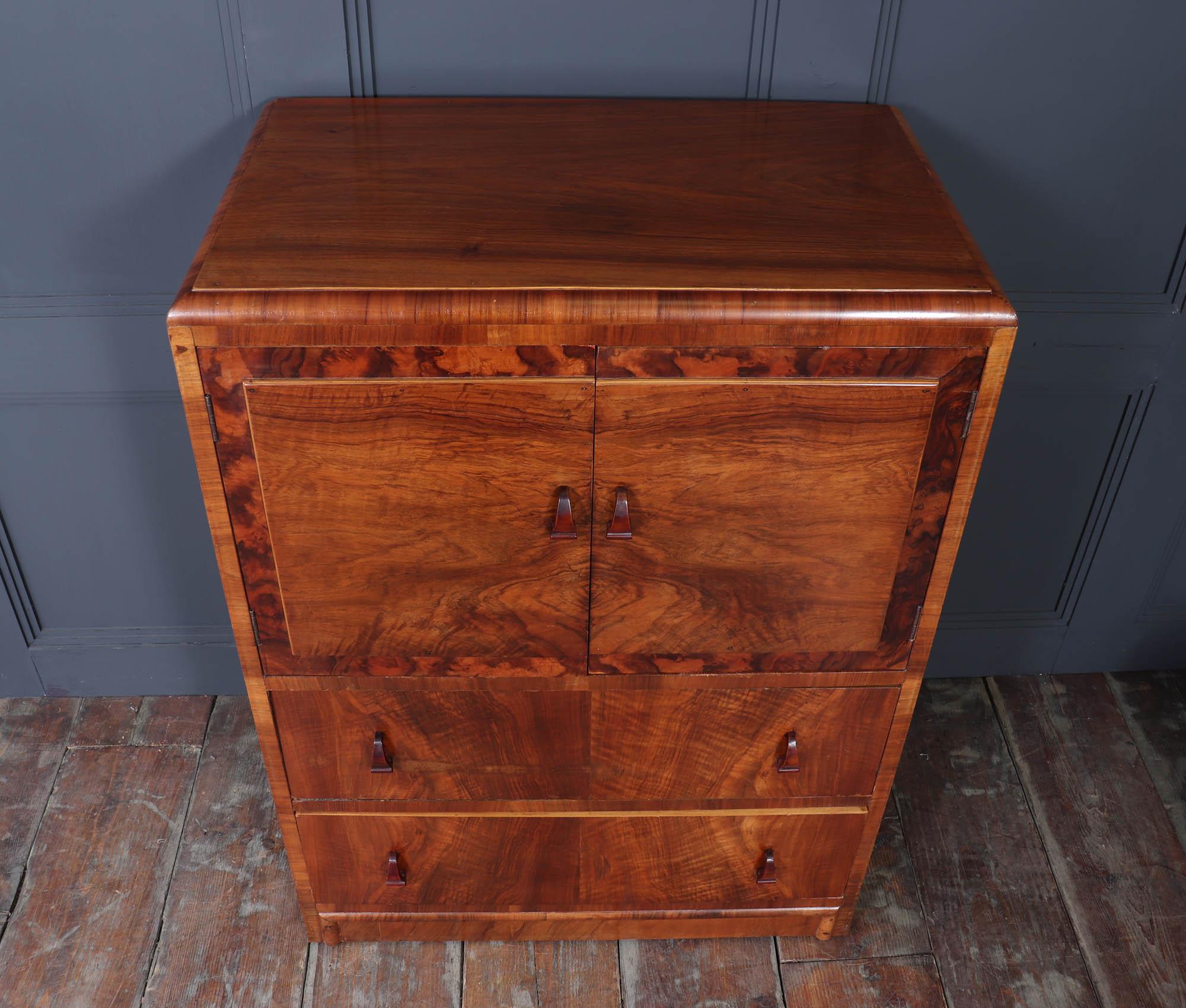 Art Deco Tallboy in Walnut
 A walnut linen cupboard tallboy that effortlessly combines elegance and functionality. This stunning piece of furniture not only enhances your living space with its rich, warm tones but also offers practical storage