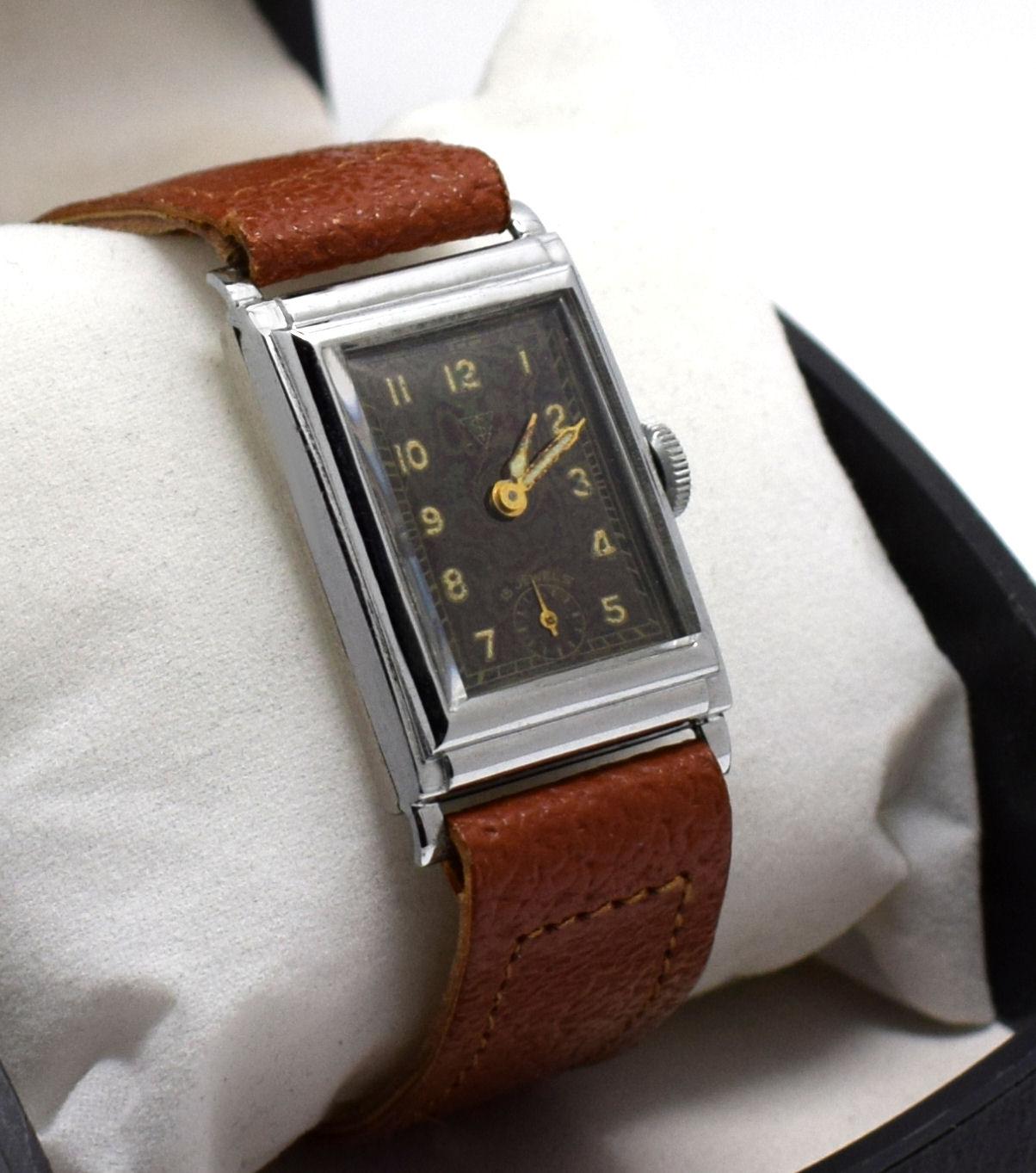 For your consideration is this very stylish Art Deco, 1930s men’s tank watch made in Germany. Beautiful condition throughout, the chrome is as good as you could hope for, with original old sales label still attached, this watch is old new stock and