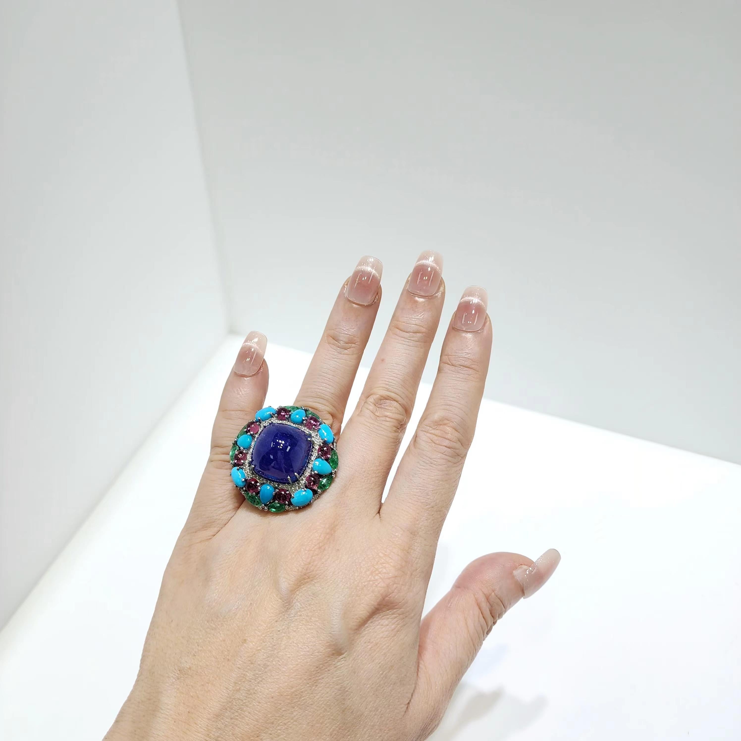 Introducing a mesmerizing Ring in Silver, this exquisite piece showcases a breathtaking combination of gemstones. At the center, a vibrant Tanzanite is surrounded by a rich arrangement of Emeralds, Pink Tourmalines, and Persian Turquoises, creating