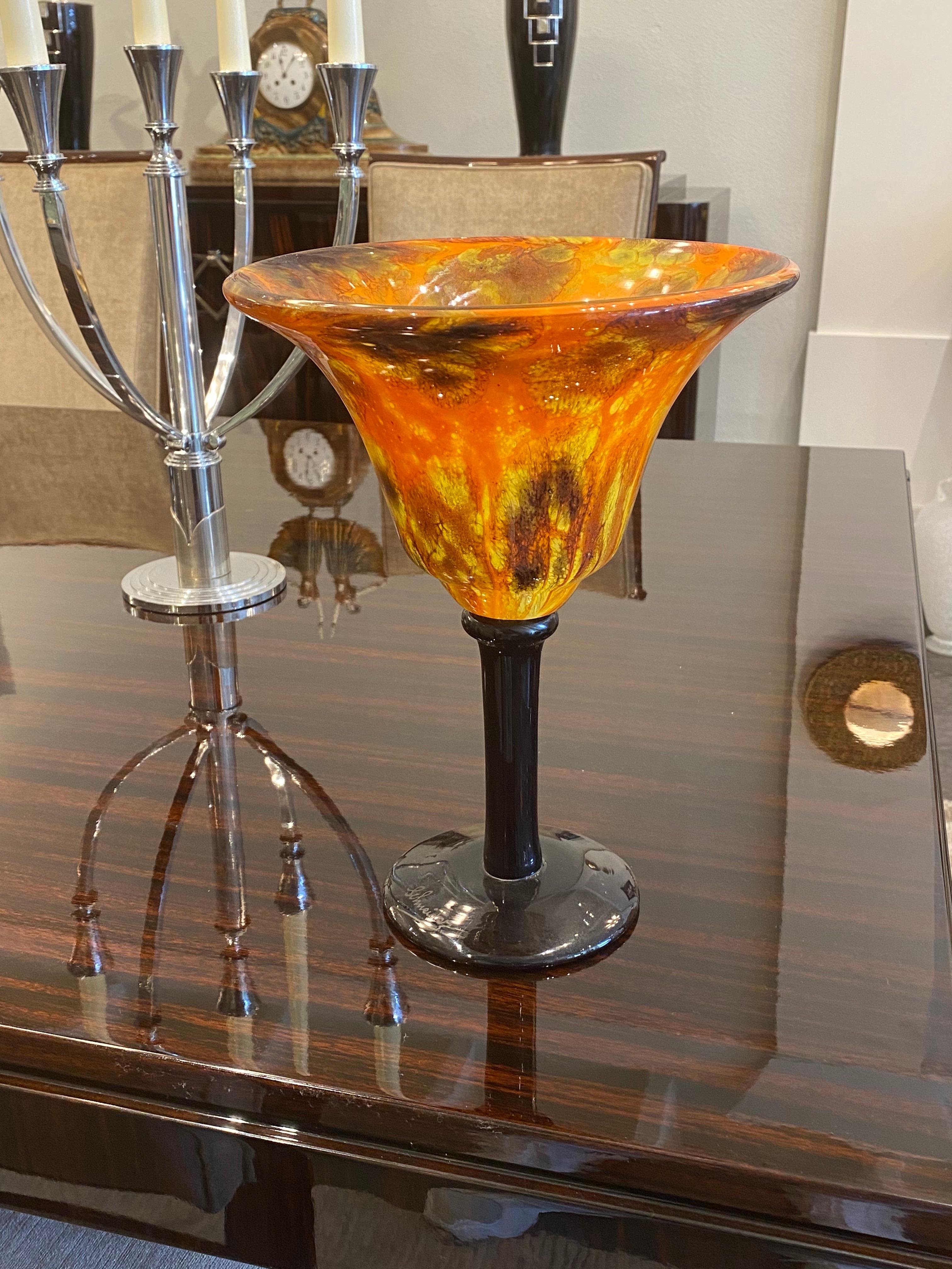 A goblet in Red, Orange, Yellow and speckled Brown in powdered glass.  Stem and foot in Violet powdered glass.  This piece belongs to the Marbrines serie from Charles Schnedier.
Signature: Schneider

Charles Schneider was a renowned glassmaker