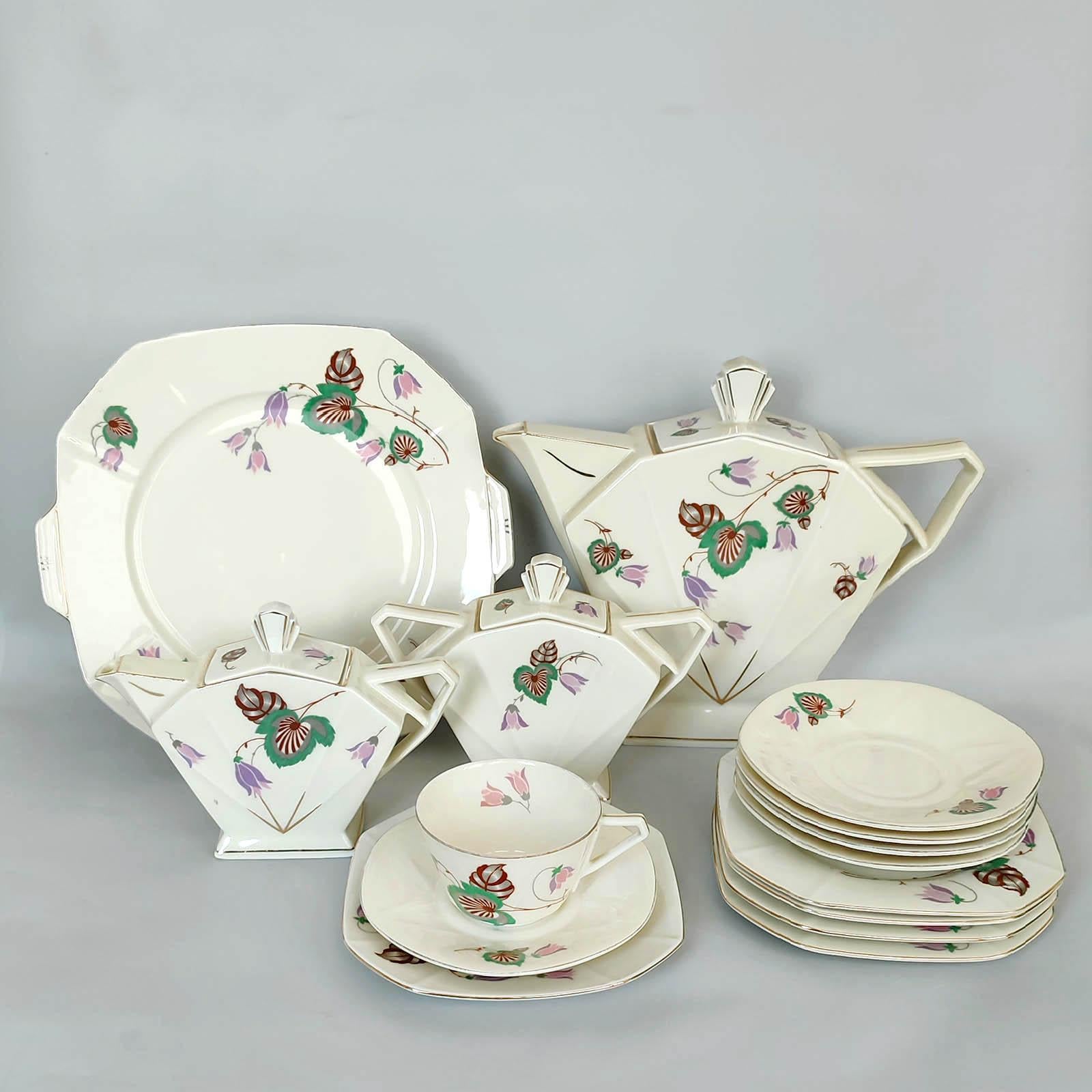Delightfully angular pure Art Deco porcelain tea / coffee and dessert serving set for 5 by Victoria, Czechoslovakia. 
Comprising: jug, sugar bowl, milk jug, serving plate, 5 cups with saucers and 5 dessert plates.
Each piece marked to the bottom