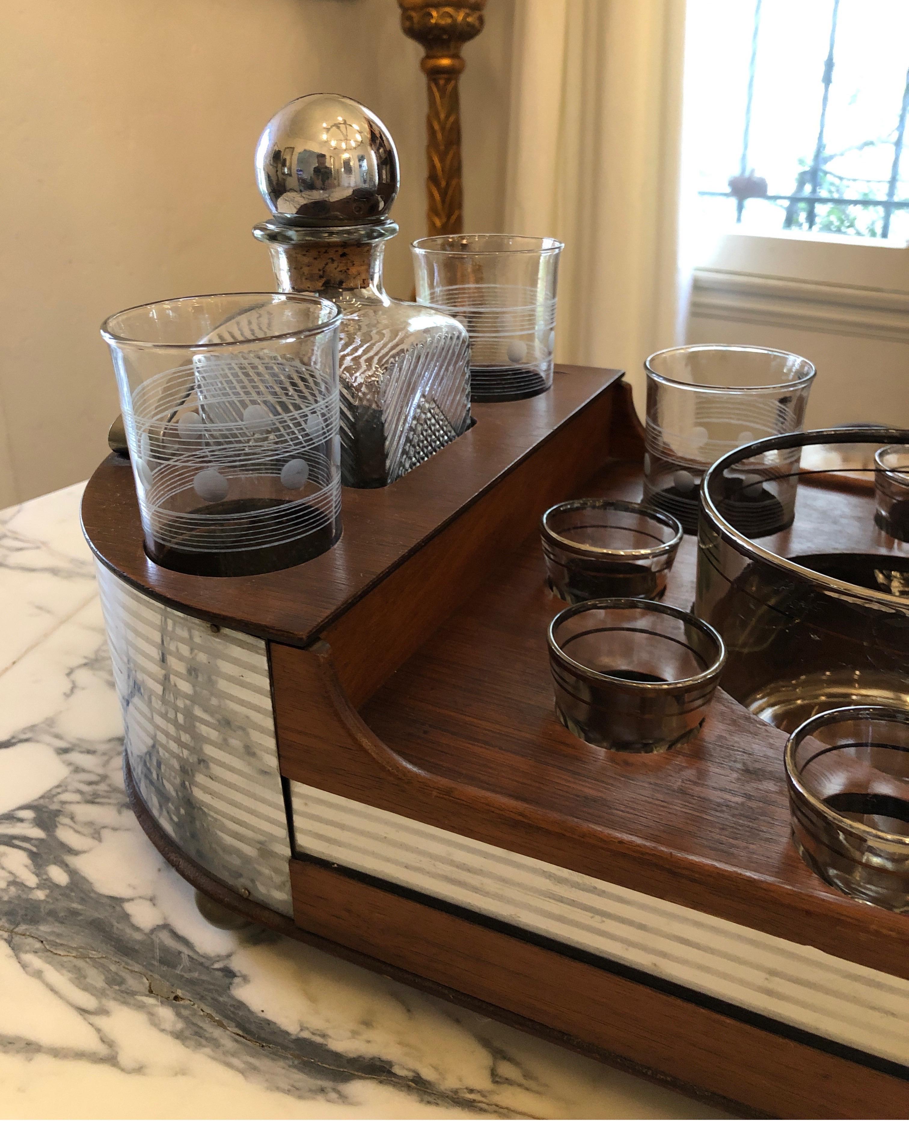 American, 1st half 20th century. Art Deco style chromed metal and wood portable bar or drinks set, the fitted tray having an oblong shape with rounded handles to each end and Inserts for bourbon decanter, scotch decanter, six shot glasses, six