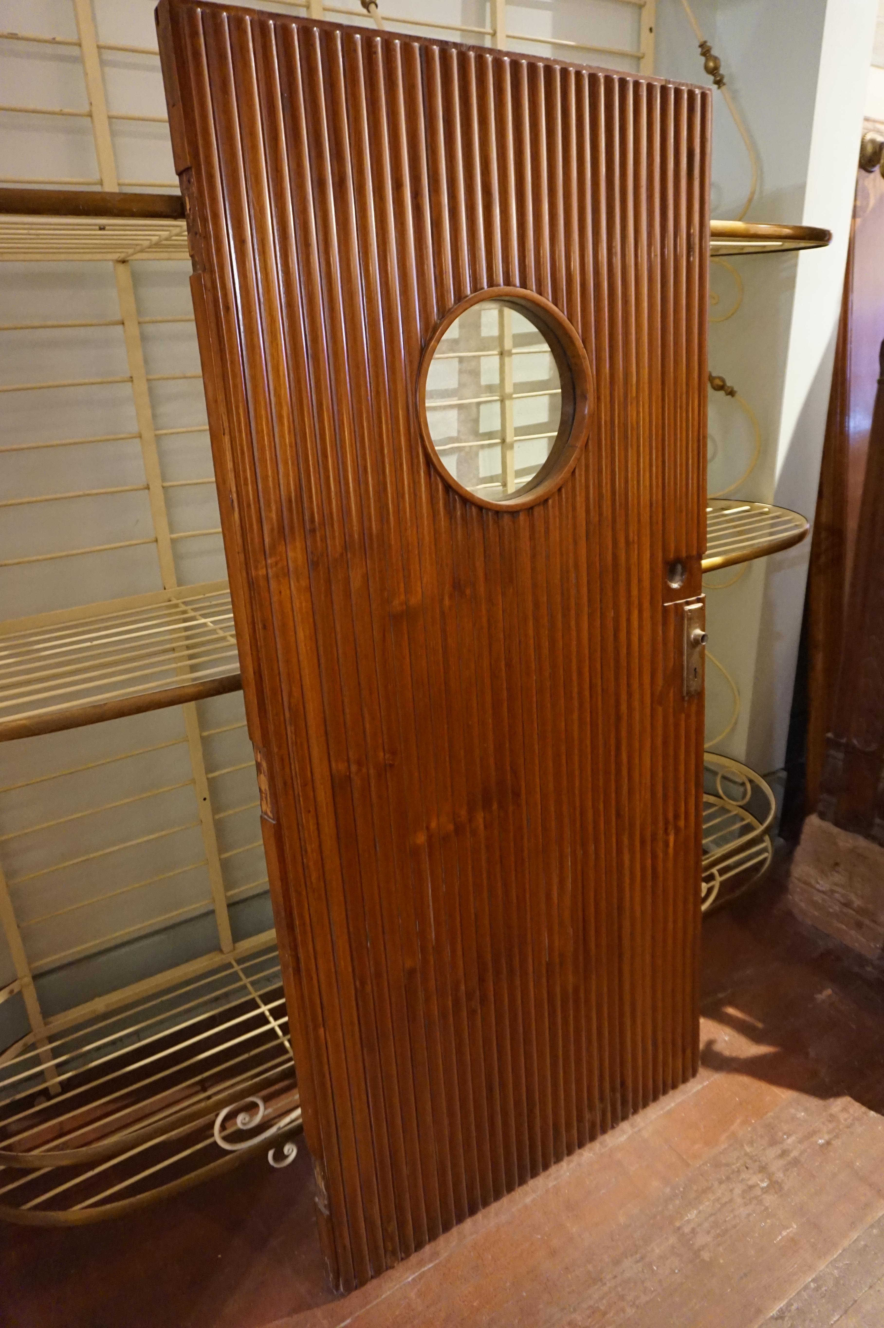 Solid teak hand carved exquisite ship door with porthole and fine joinery work. Hardware remnant of brass handle less hinges intact. Measures: 2