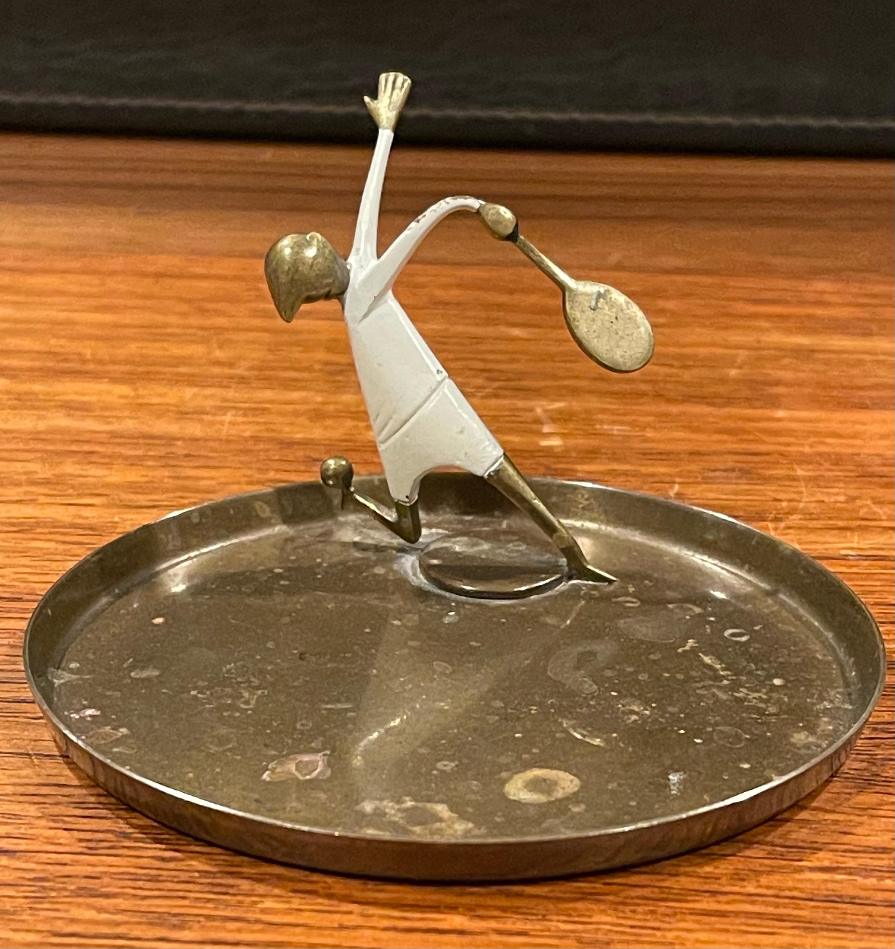 A very cool Art Deco tennis player trinket dish in brass by Austrian designer and artist Karl Hagenauer, circa 1940s. Marked on underside 