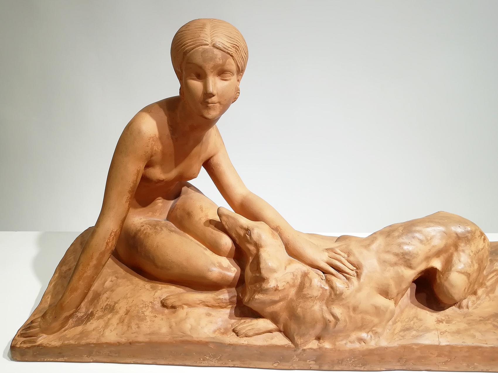 Georges Coste Art Deco terracotta sculpture of a young women with her Borzoi, her dog lying beside her on a rectangular terrace.
Signed on the terrace and stamped “Susse Frères” publishers in Paris.
Georges Coste was an early 20th century French