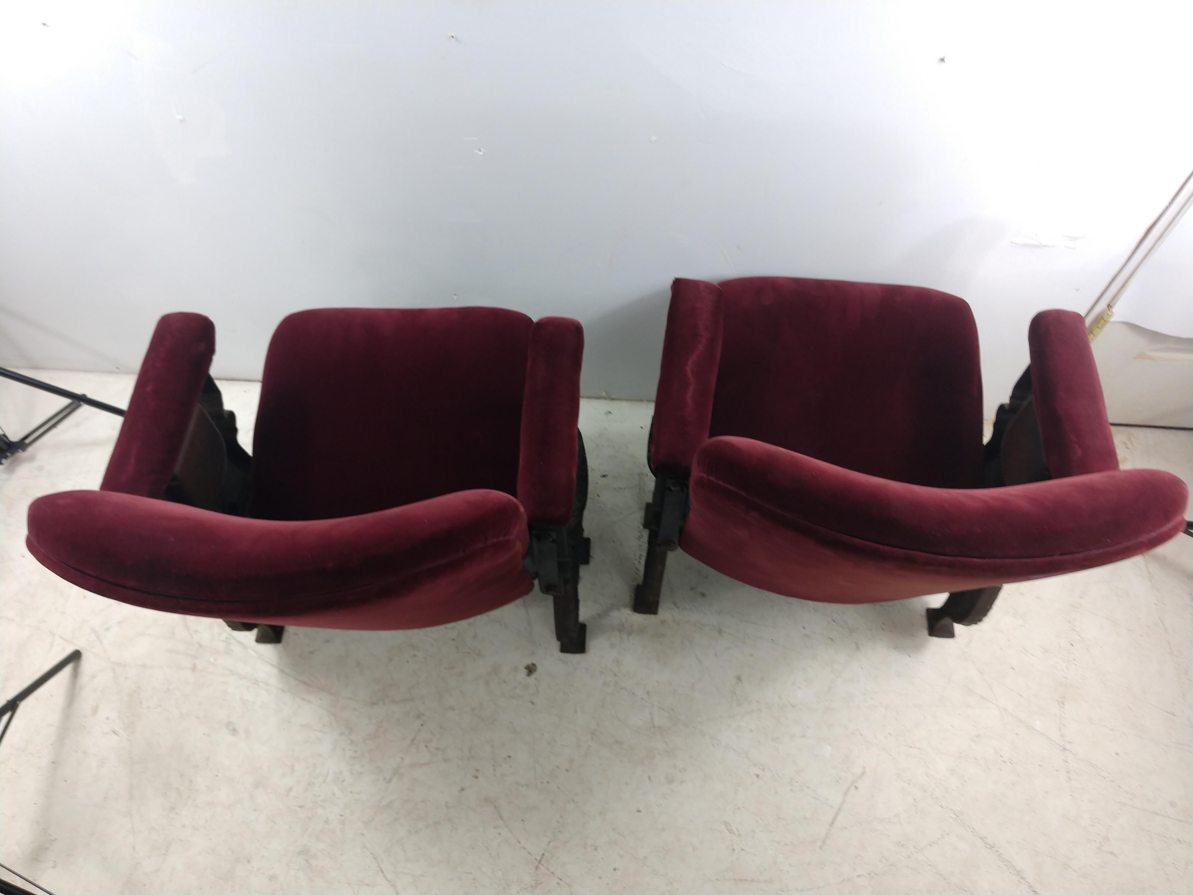 Fabulous set of two cast iron with patinated sides. Made by the American Seating Co in 1927 for a NYC Theatre which was renovated 40 yrs ago. Chairs are separate with castings on both sides and likely cane from a balcony loge section. In excellent
