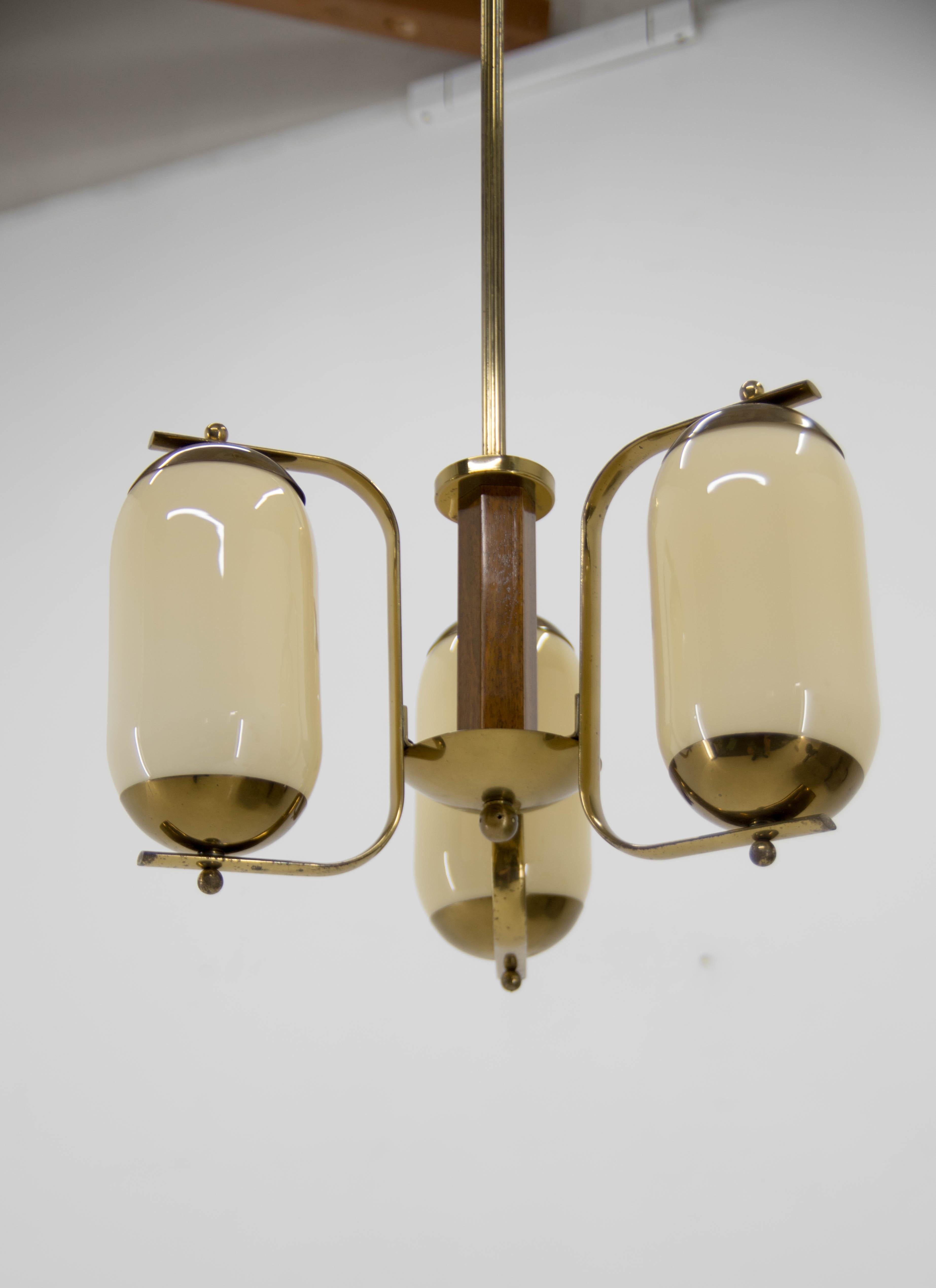 Unusual Art Deco chandelier made of brass, glass and wood.
Cleaned, polished, rewired.
Central rod can be shorten on request.
3x40W, E25-E27 bulbs
US wiring compatible