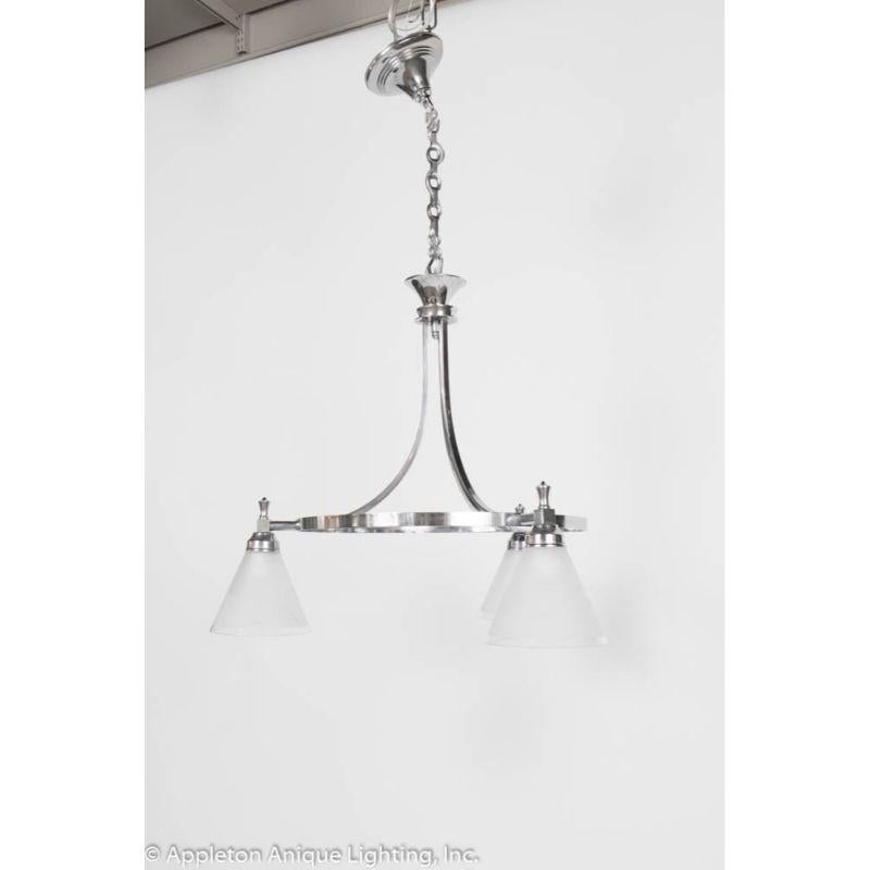 Three lights, frosted original shades. French. Chrome finish with frosted glass. Fixture only is 21″, setup with chain to be 32″ overall, can be shortened to 24″.

Material: Chrome, art glass
Style: Art Deco, Modern
Place of Origin: France
Period