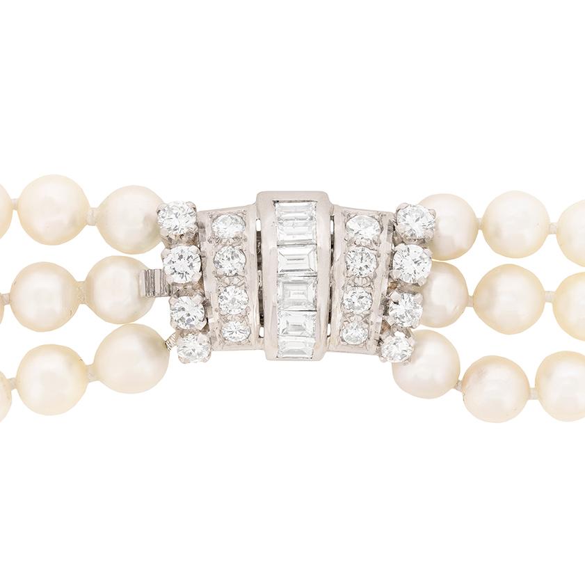 This beautiful pearl necklace shows off three graduating rows of cultures pearls. They have been strung expertly and they sit wonderfully on the wearer. The pearls are held together by a stunning diamond clasp made up of baguette cut and round